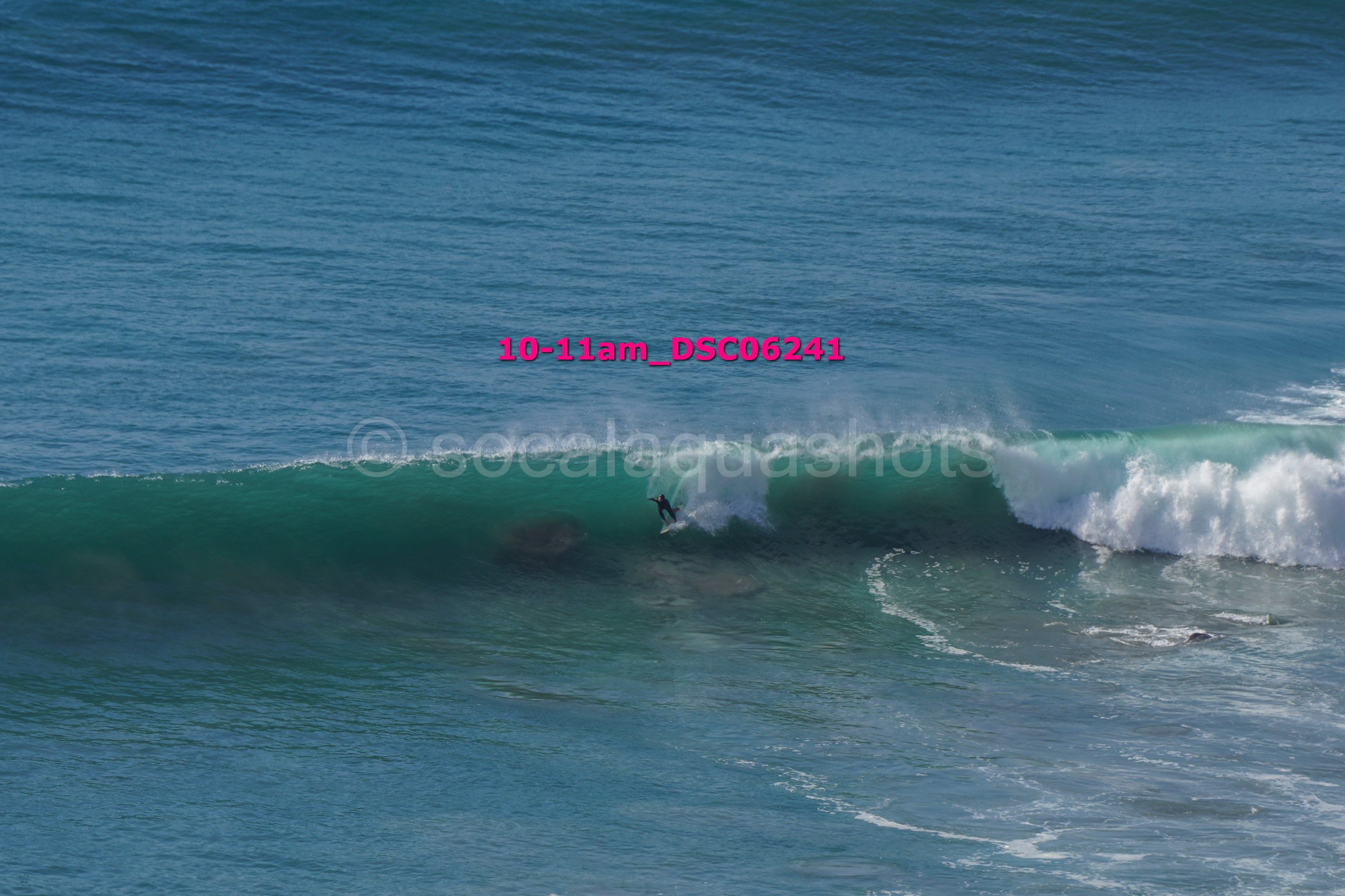 A person surfing on a wave in the ocean during daytime.