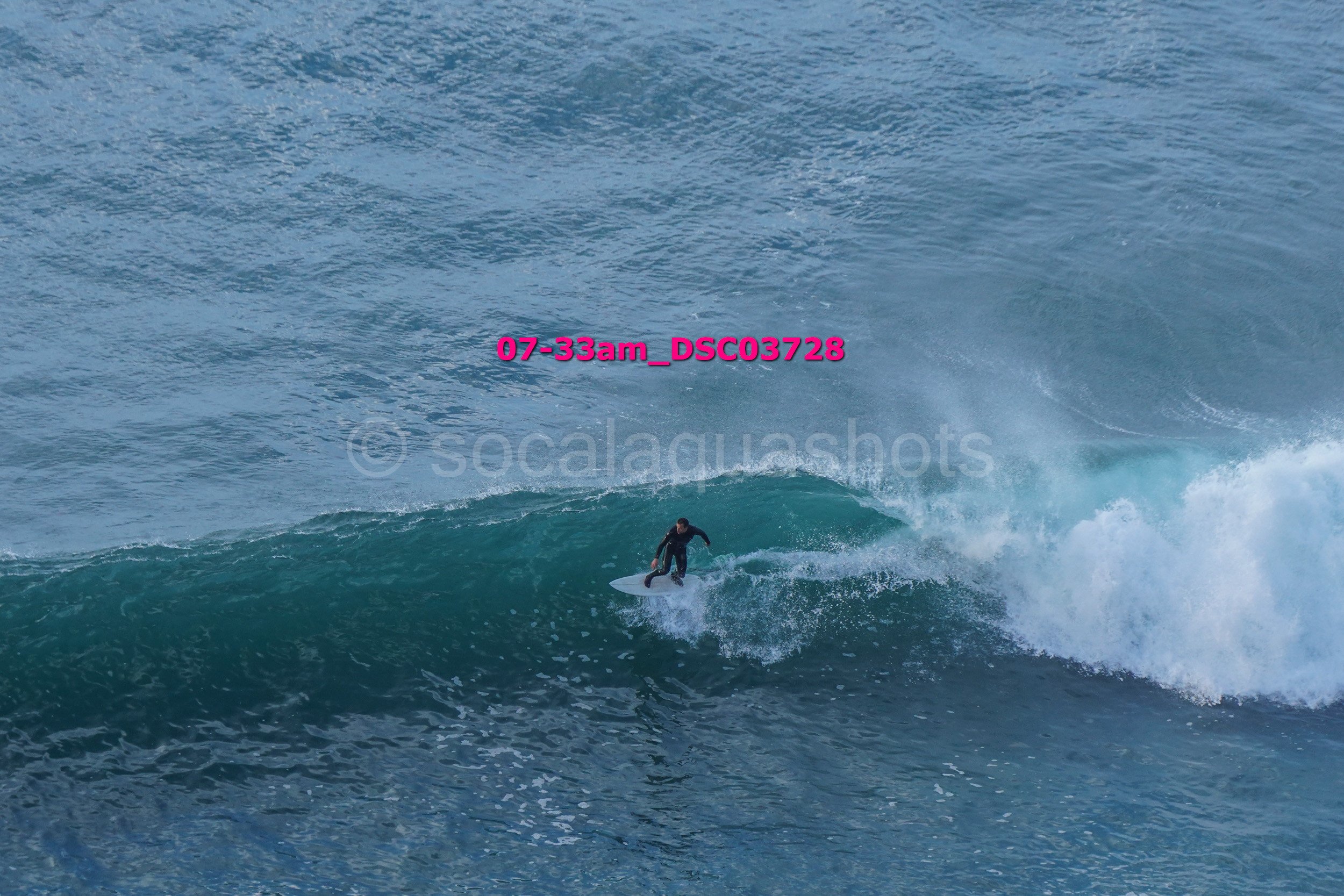 A person surfing on a wave in the ocean.