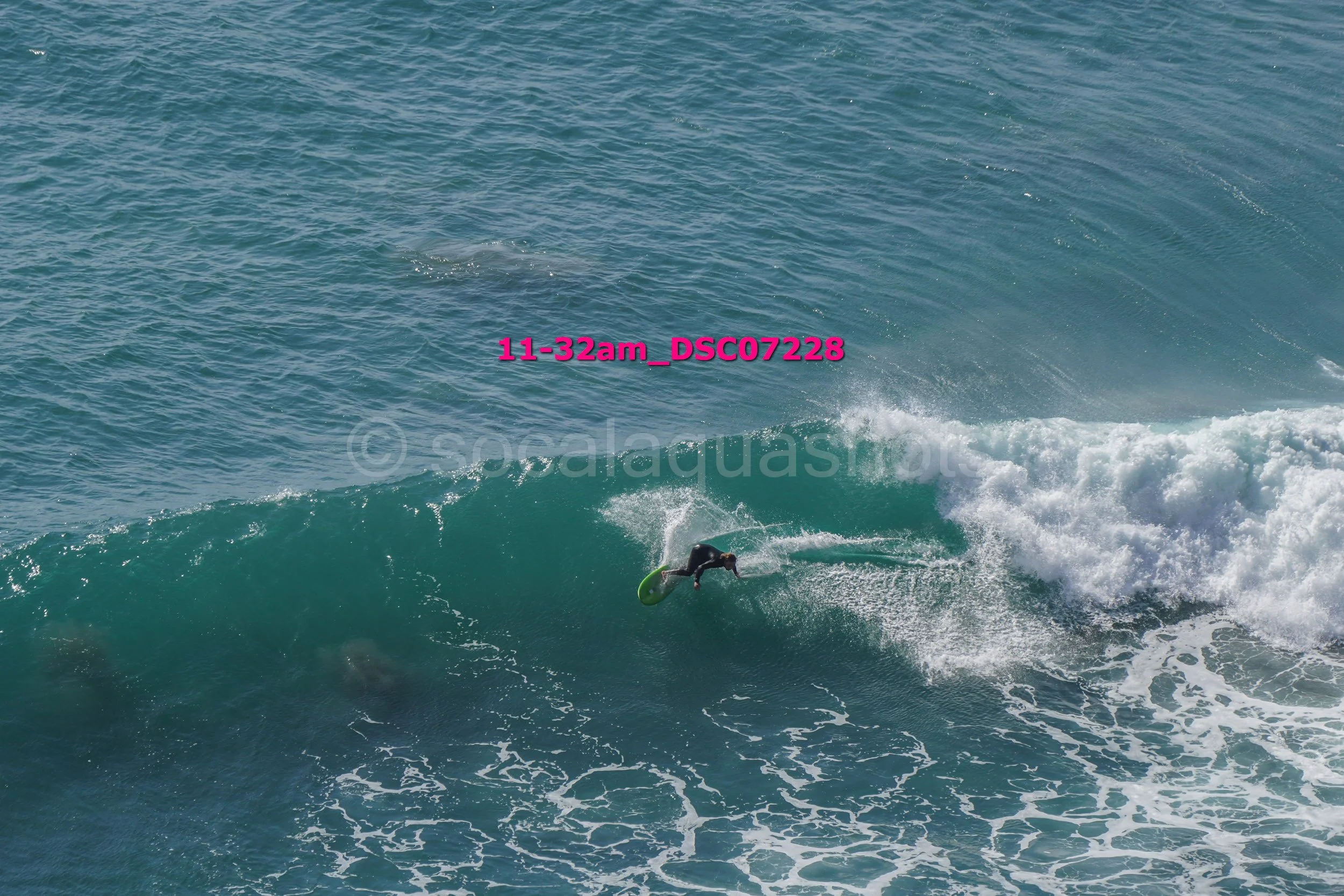 A person surfing on a wave in the ocean during daytime.