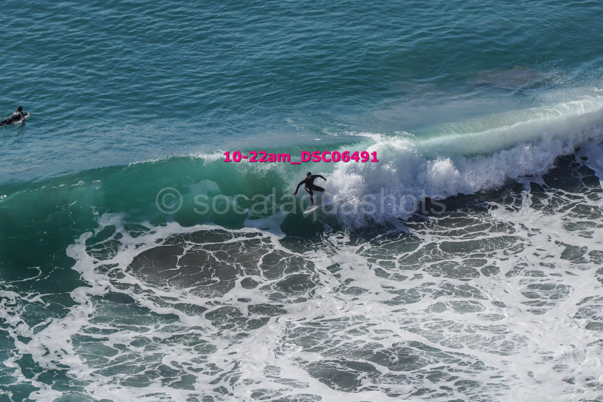 A person surfing on a wave in the ocean during daytime.