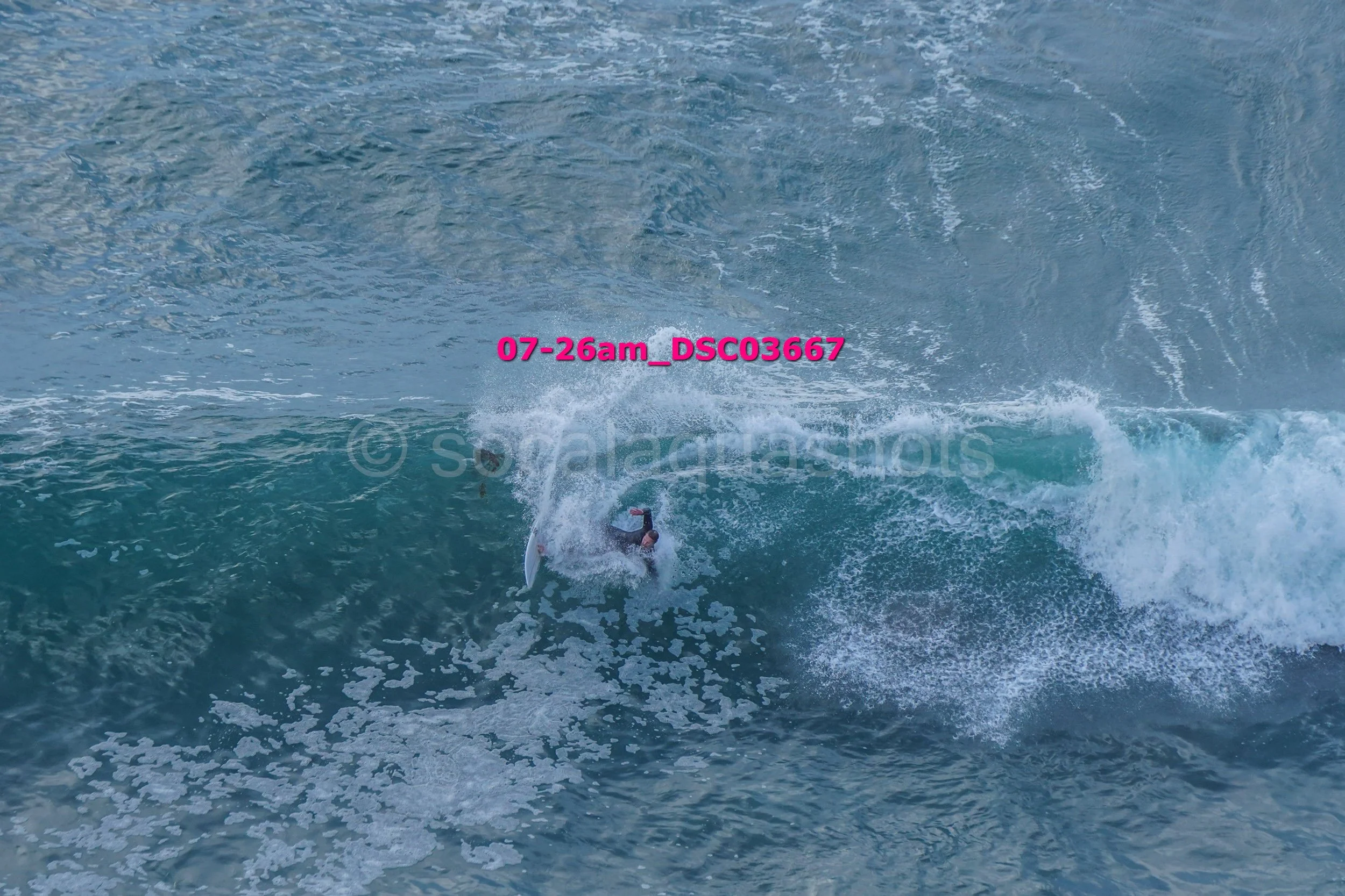 A surfer riding a large wave in the ocean.
