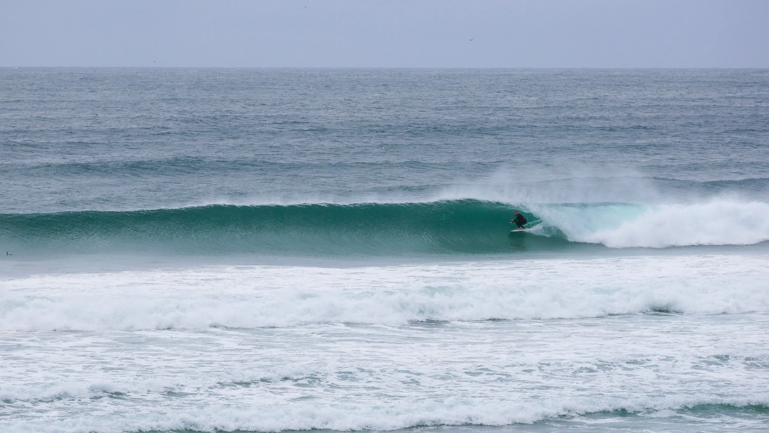 Surfer riding a wave in the ocean
