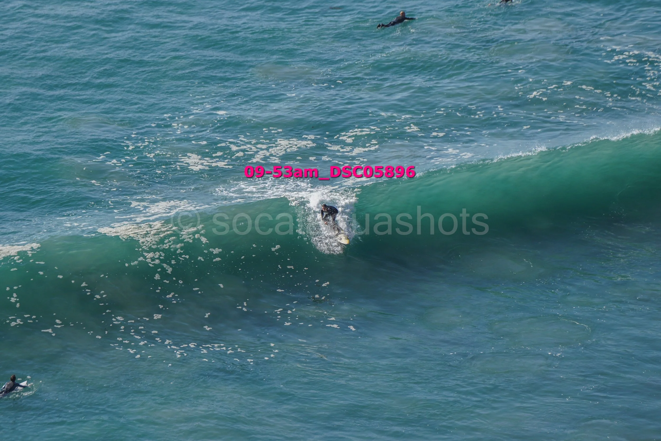 A person surfing on a large wave in the ocean