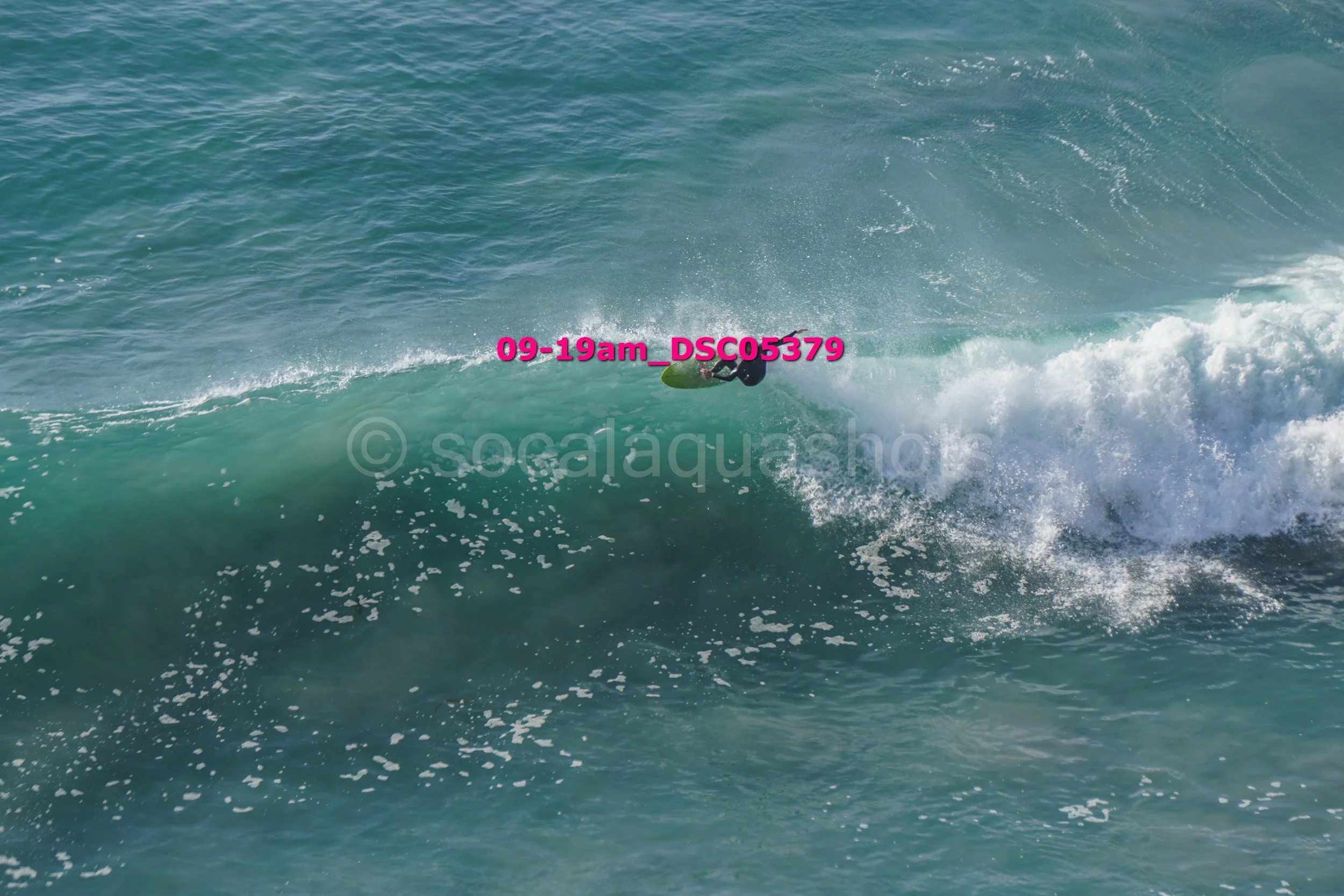 A person surfing on a wave in the ocean.