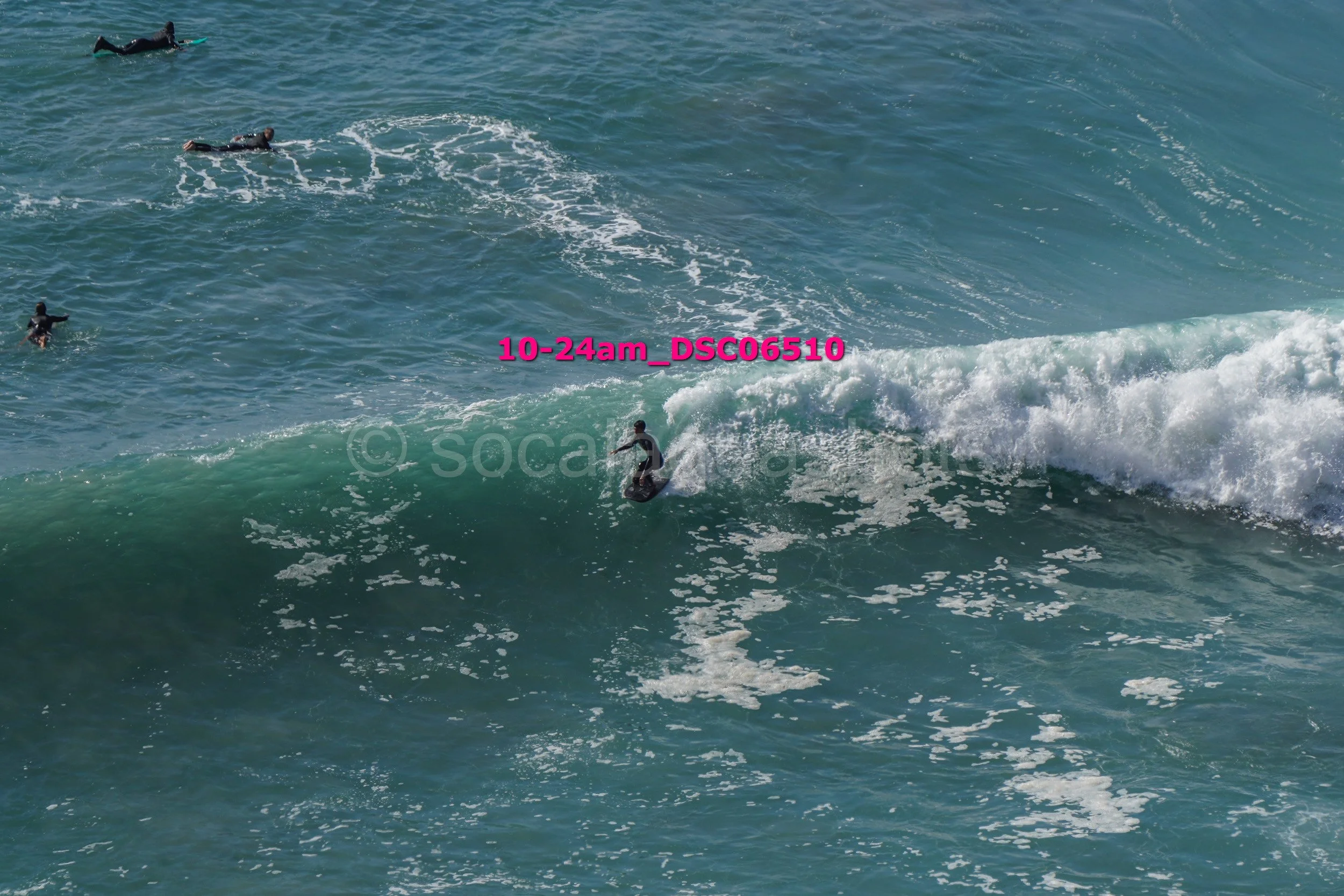 People surfing on ocean waves during daytime.