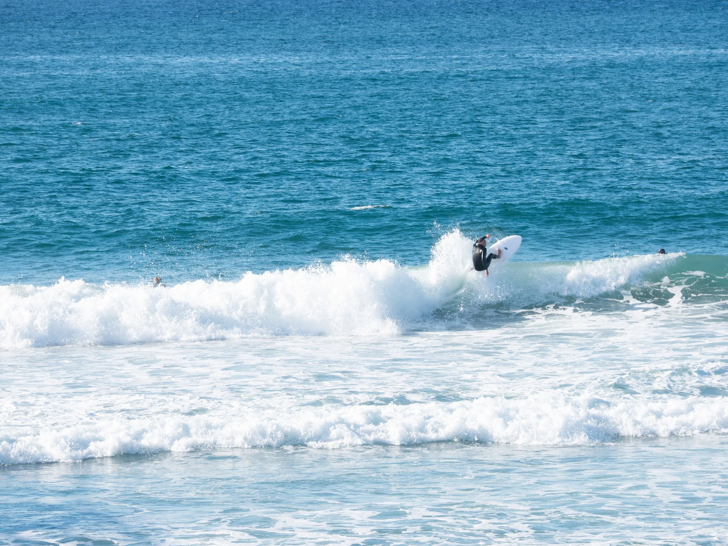 A person riding a surfboard on a wave in the ocean
