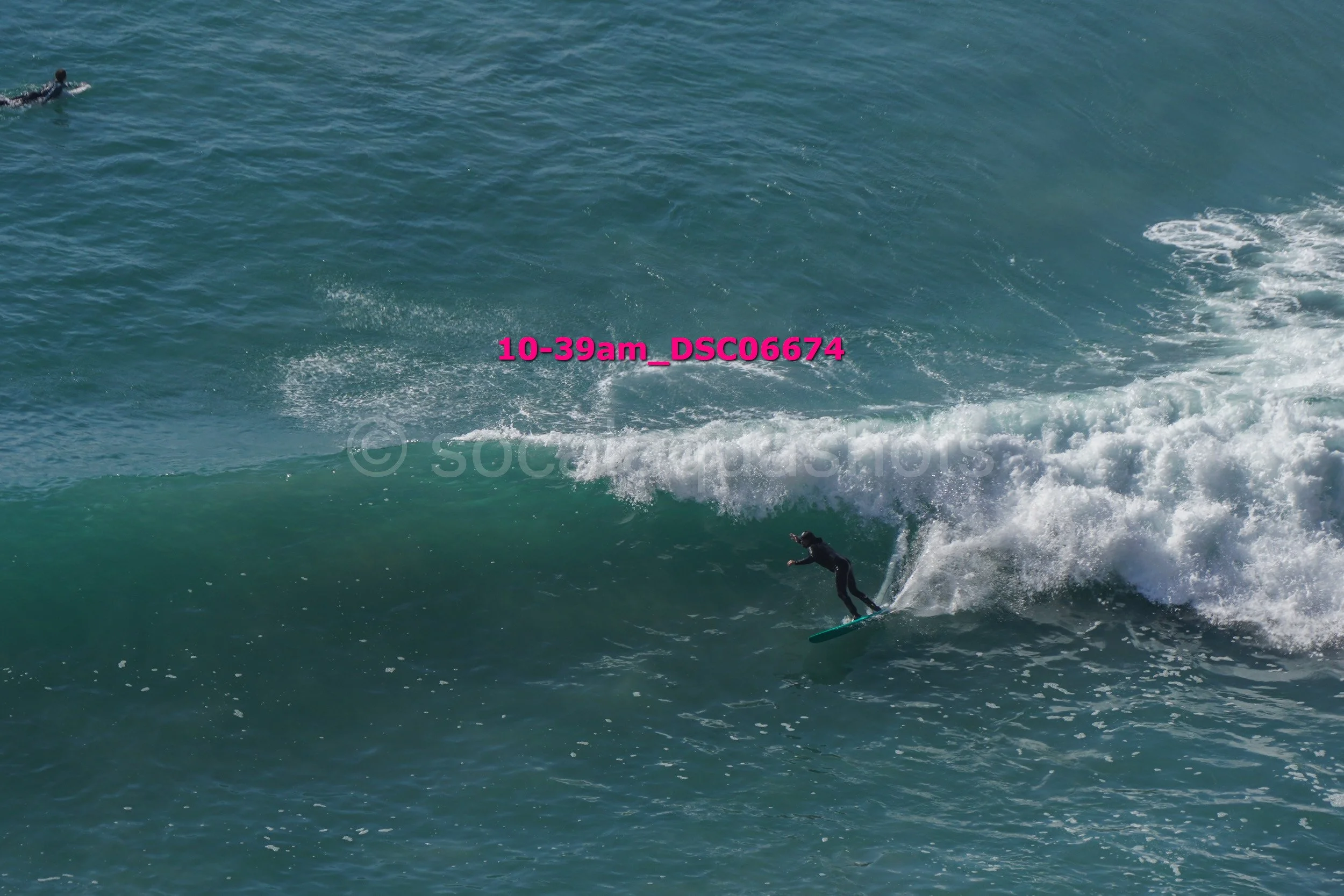 Surfer riding a wave in the ocean.