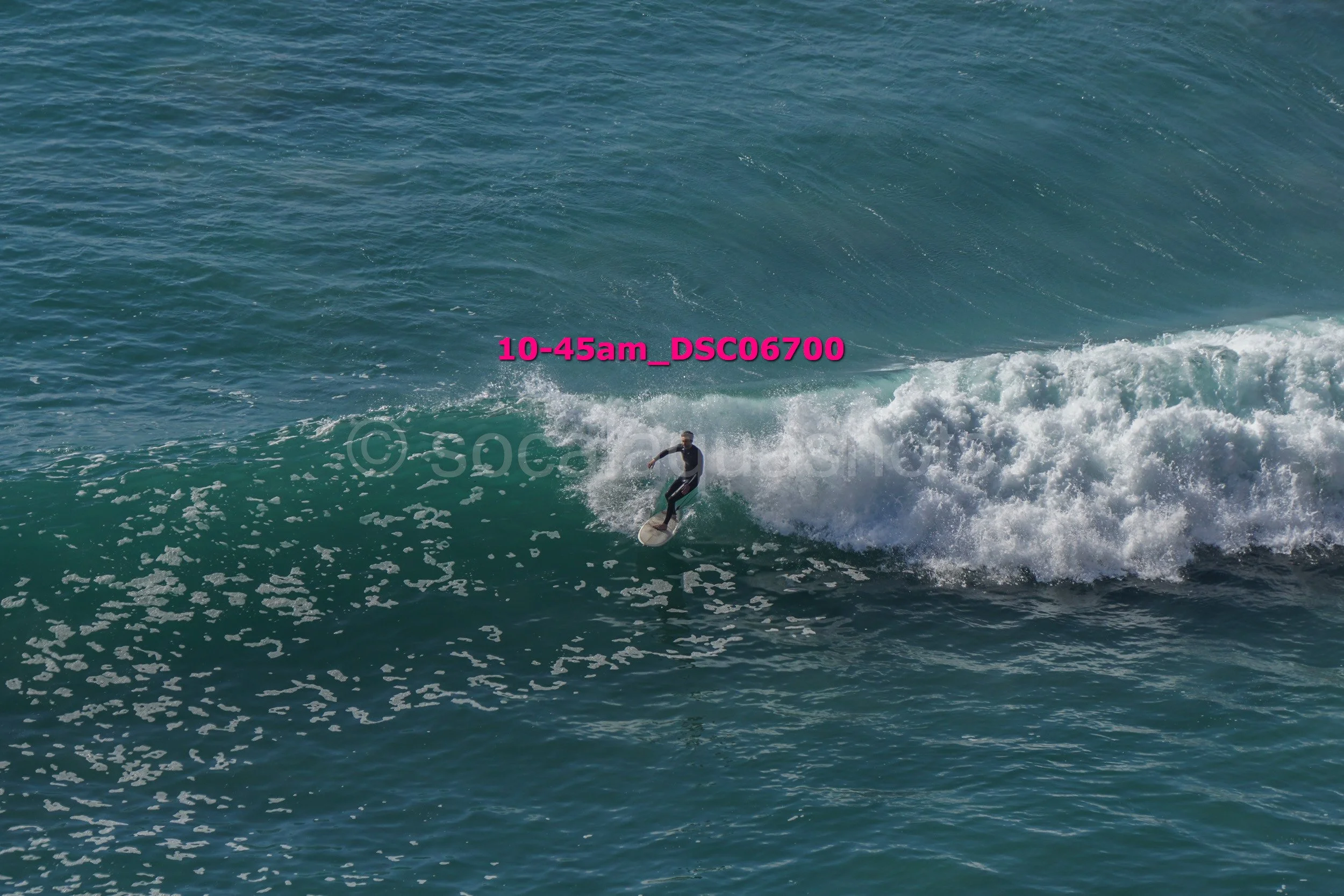 A person surfing on a wave in the ocean.