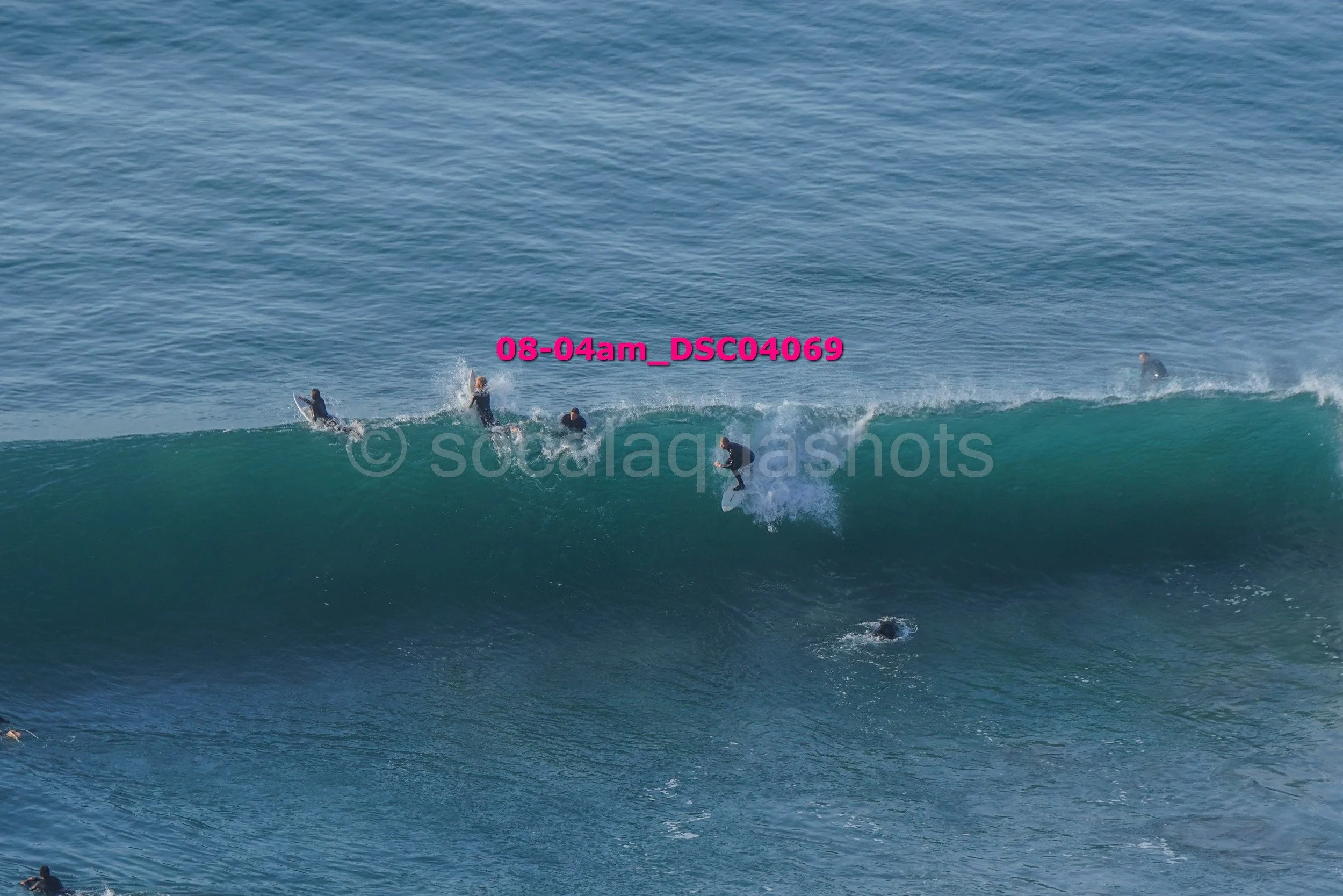People surfing on a wave in the ocean during daylight.