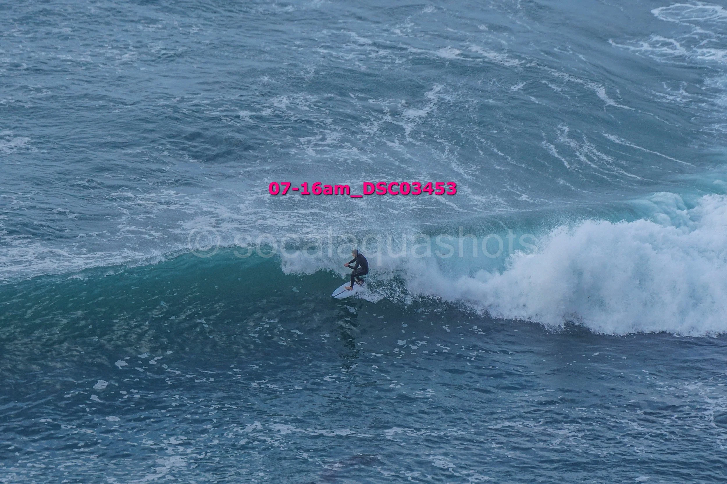 A person surfing on a wave in the ocean.