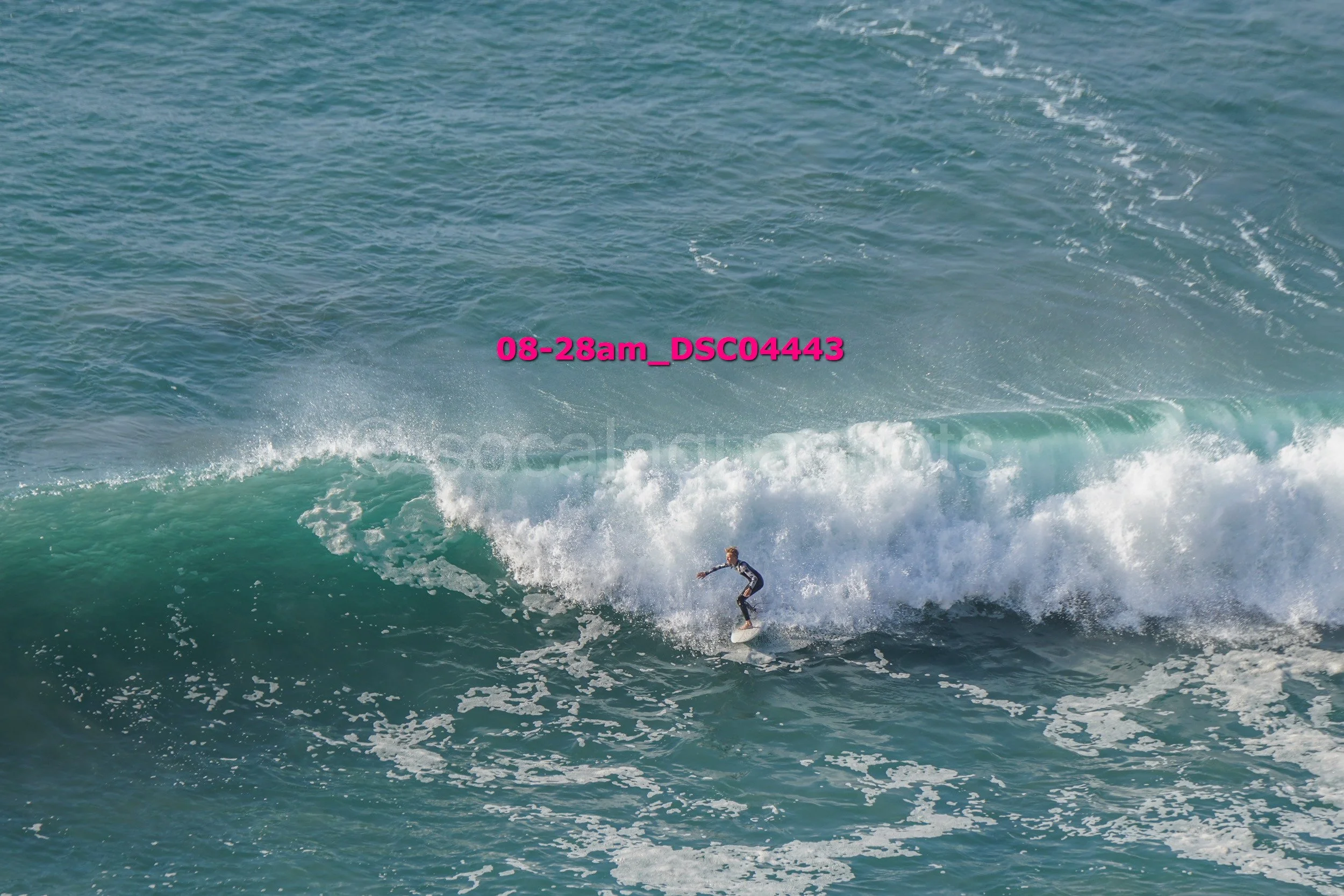 A person surfing on a wave in the ocean.