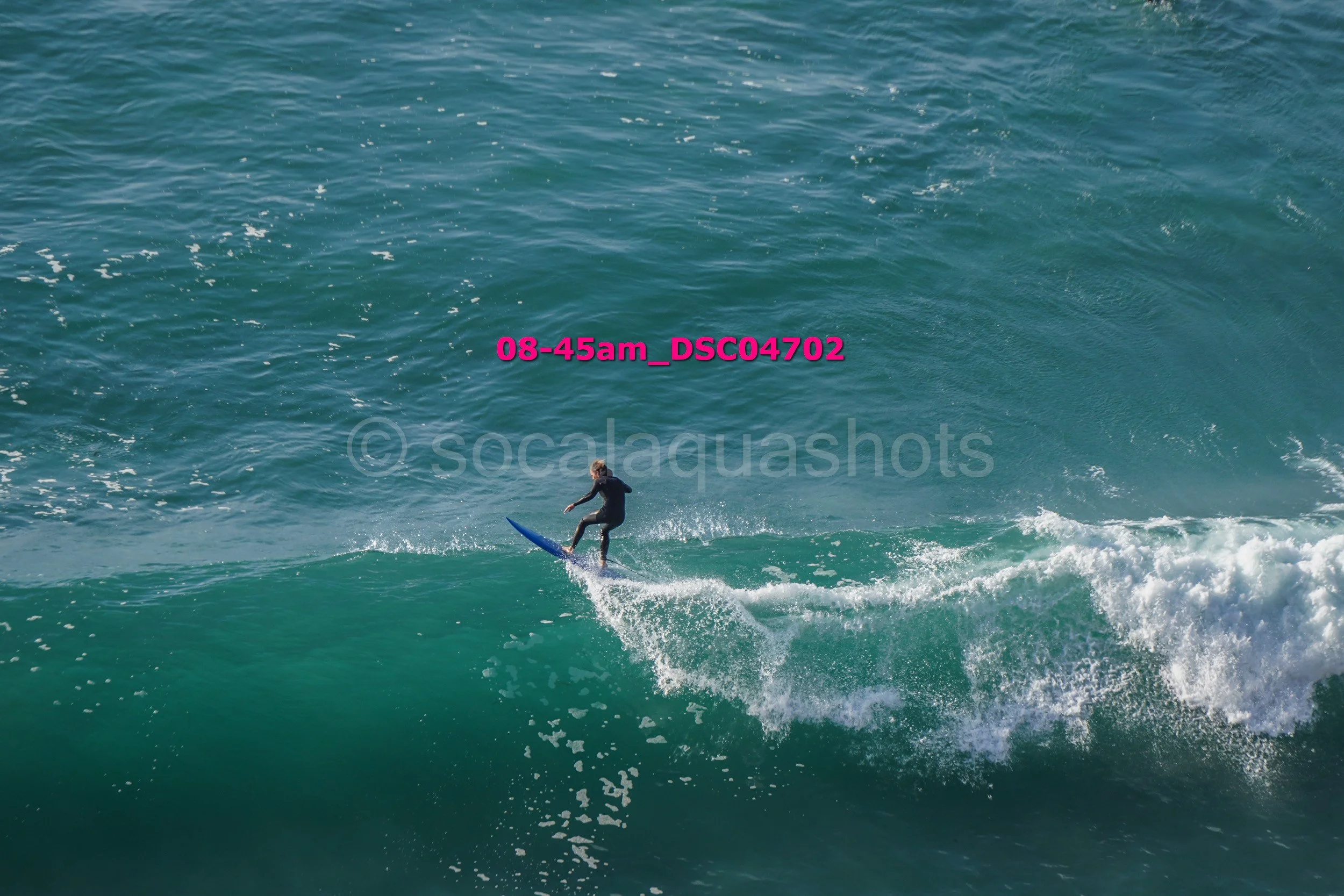 A person surfing on a wave in the ocean during daylight.