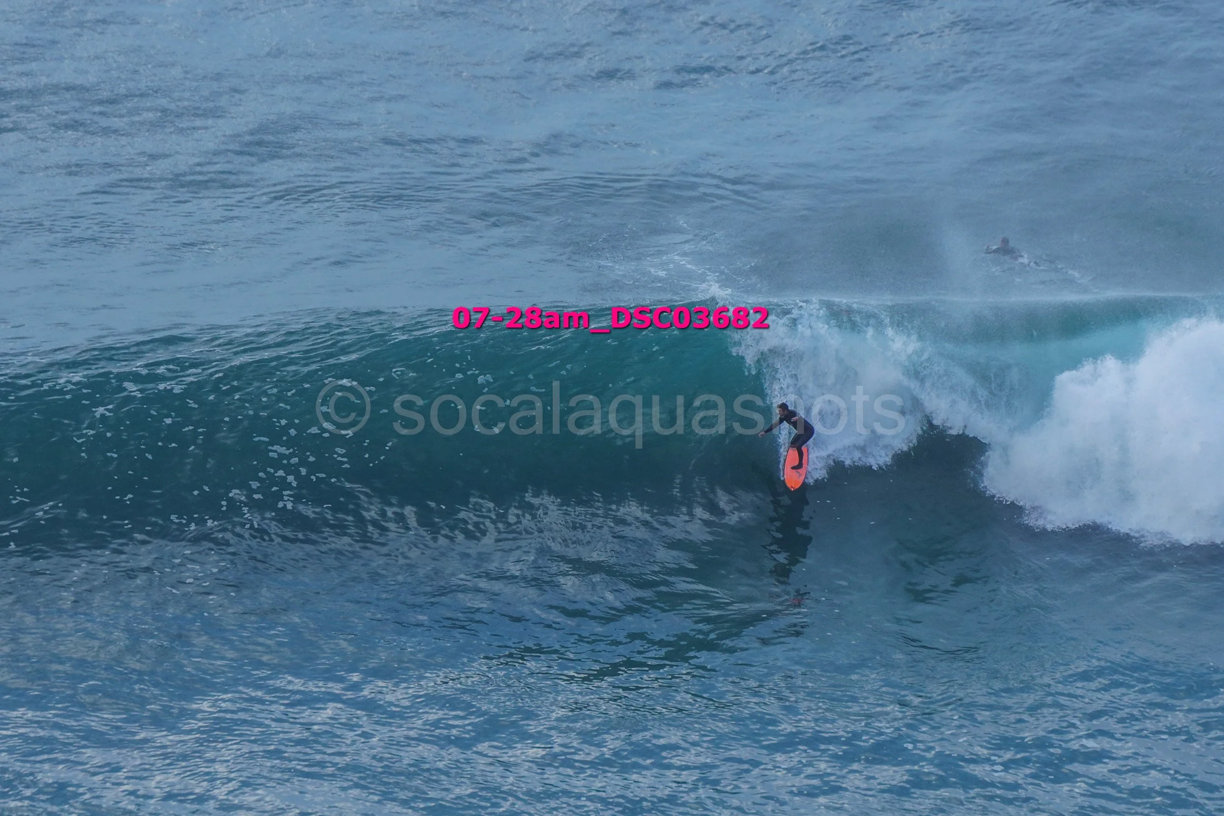 A person riding a wave on a surfboard in the ocean
