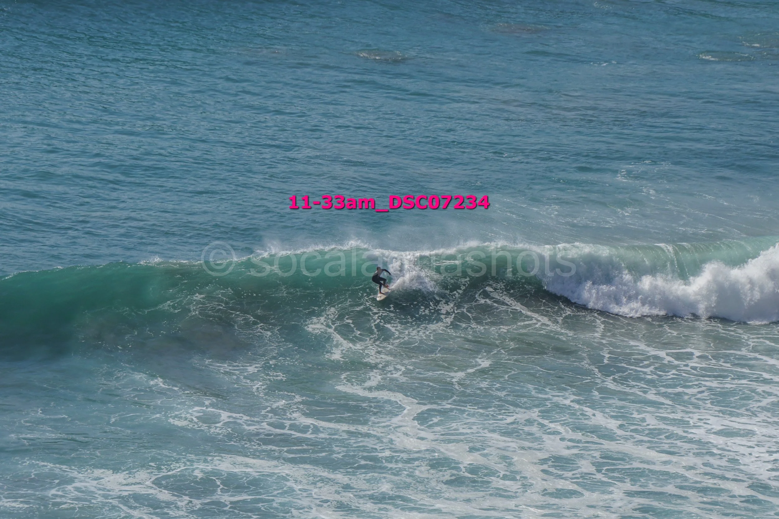 A person surfing on a wave in the ocean.