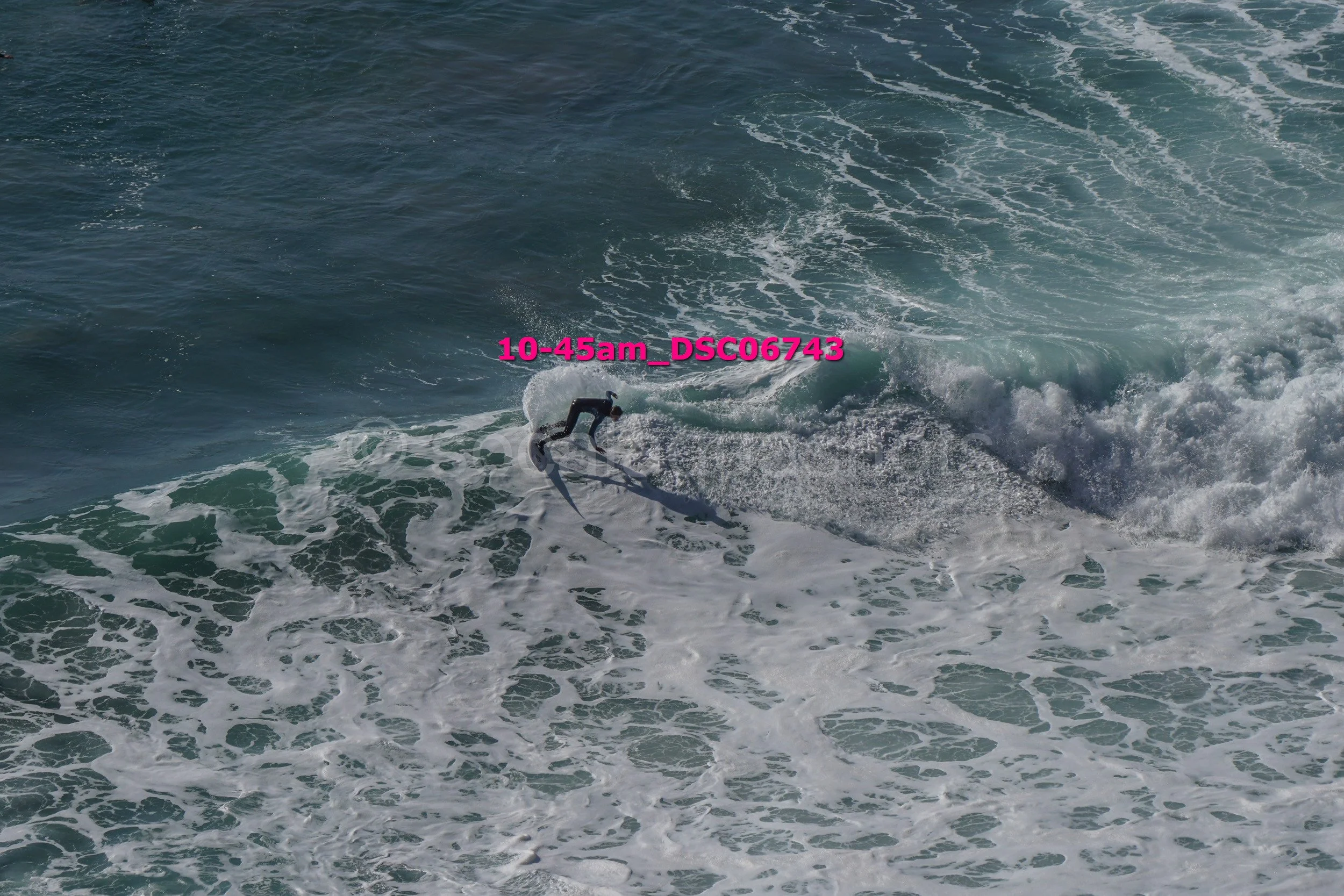 A person surfing on a wave in the ocean