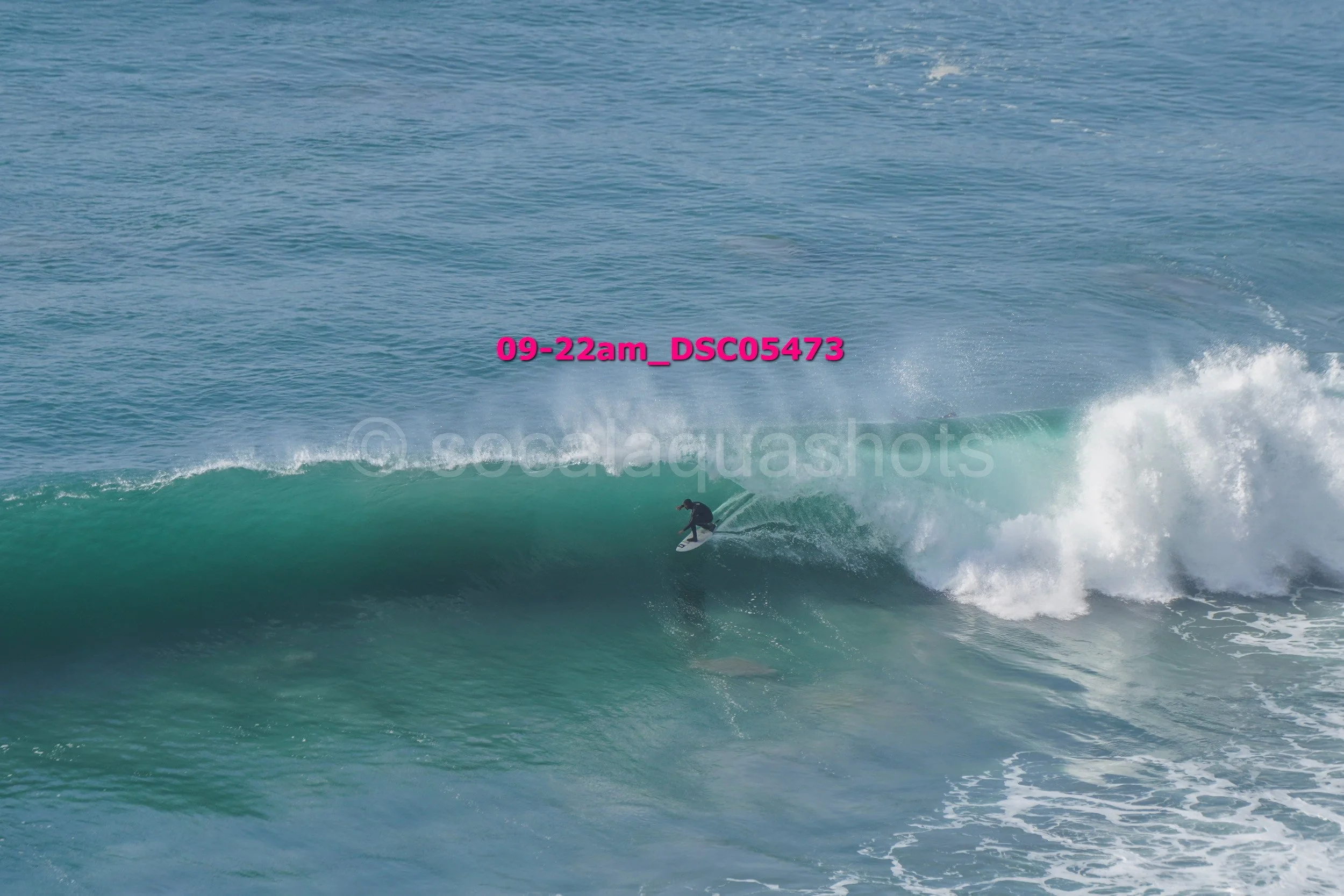 Surfer riding a wave in the ocean.