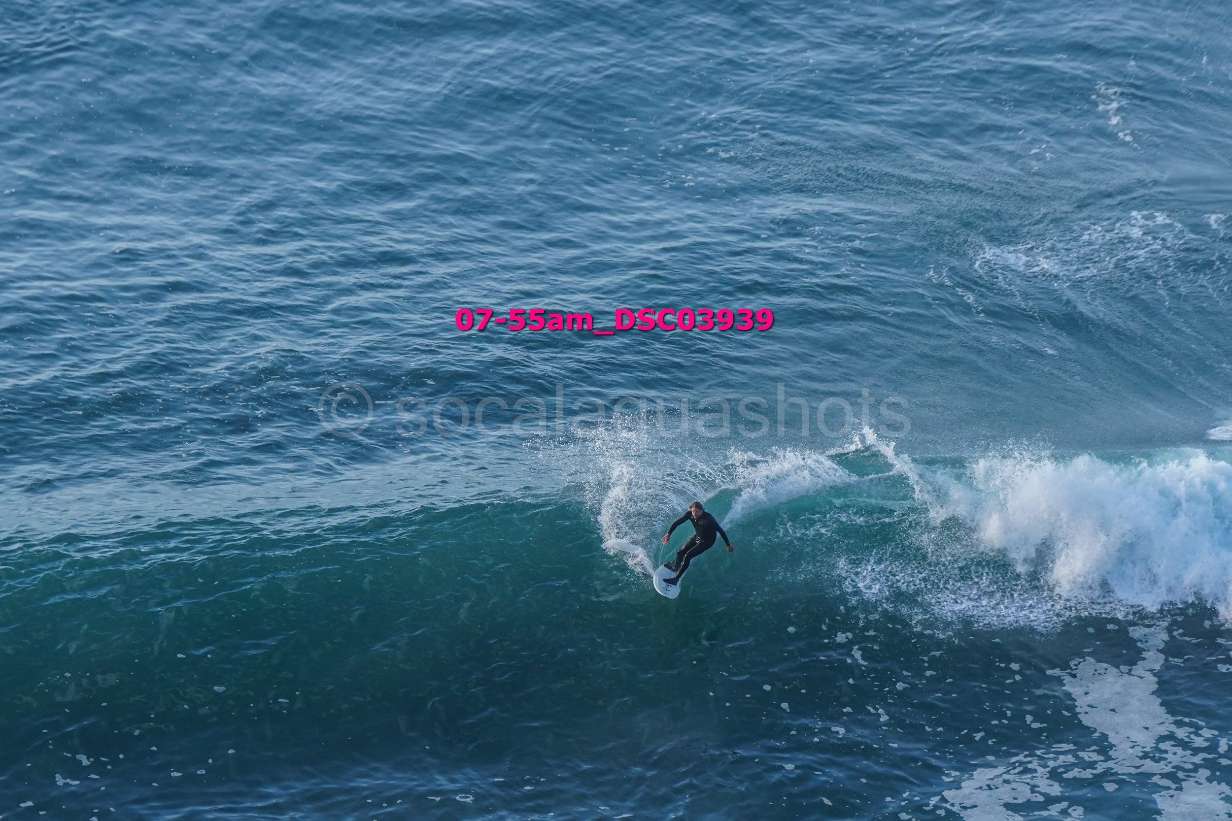 A person surfing on a wave in the ocean.