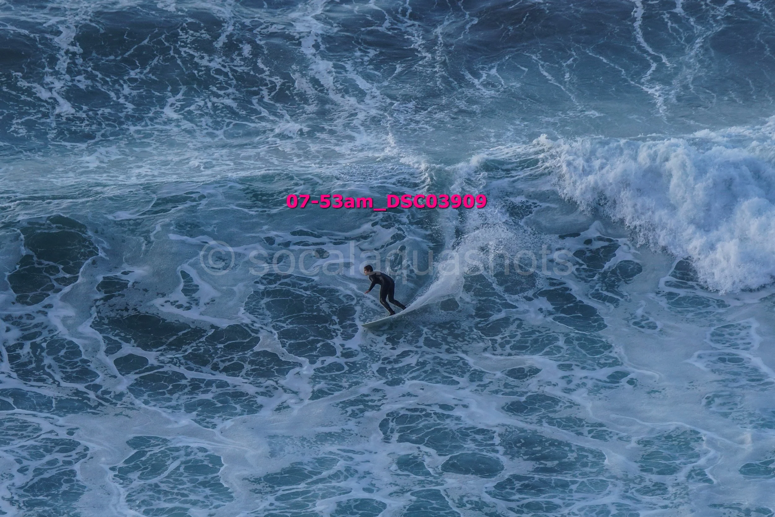 A person surfing on a wave in the ocean.