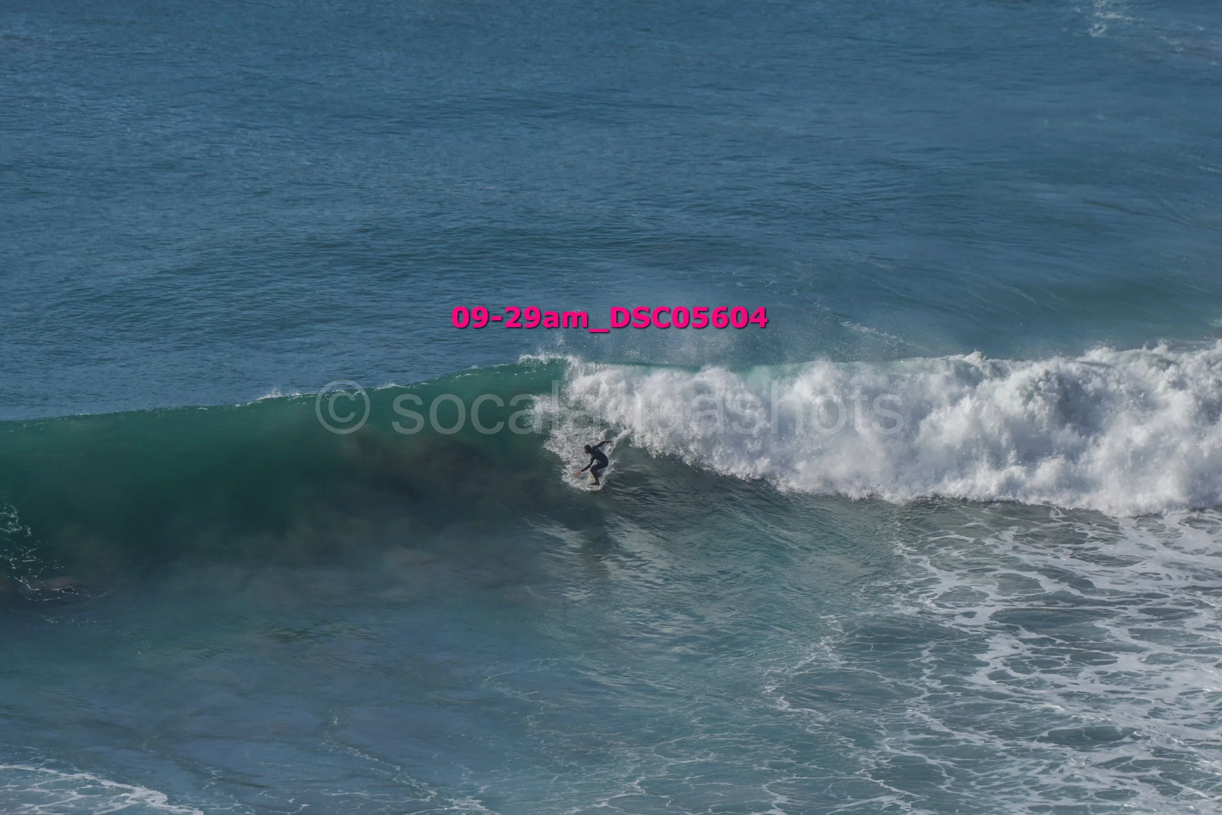 A person surfing on a wave in the ocean.