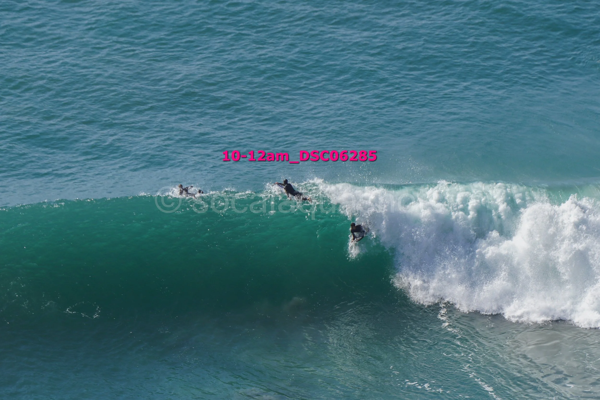 People surfing on a wave in the ocean.