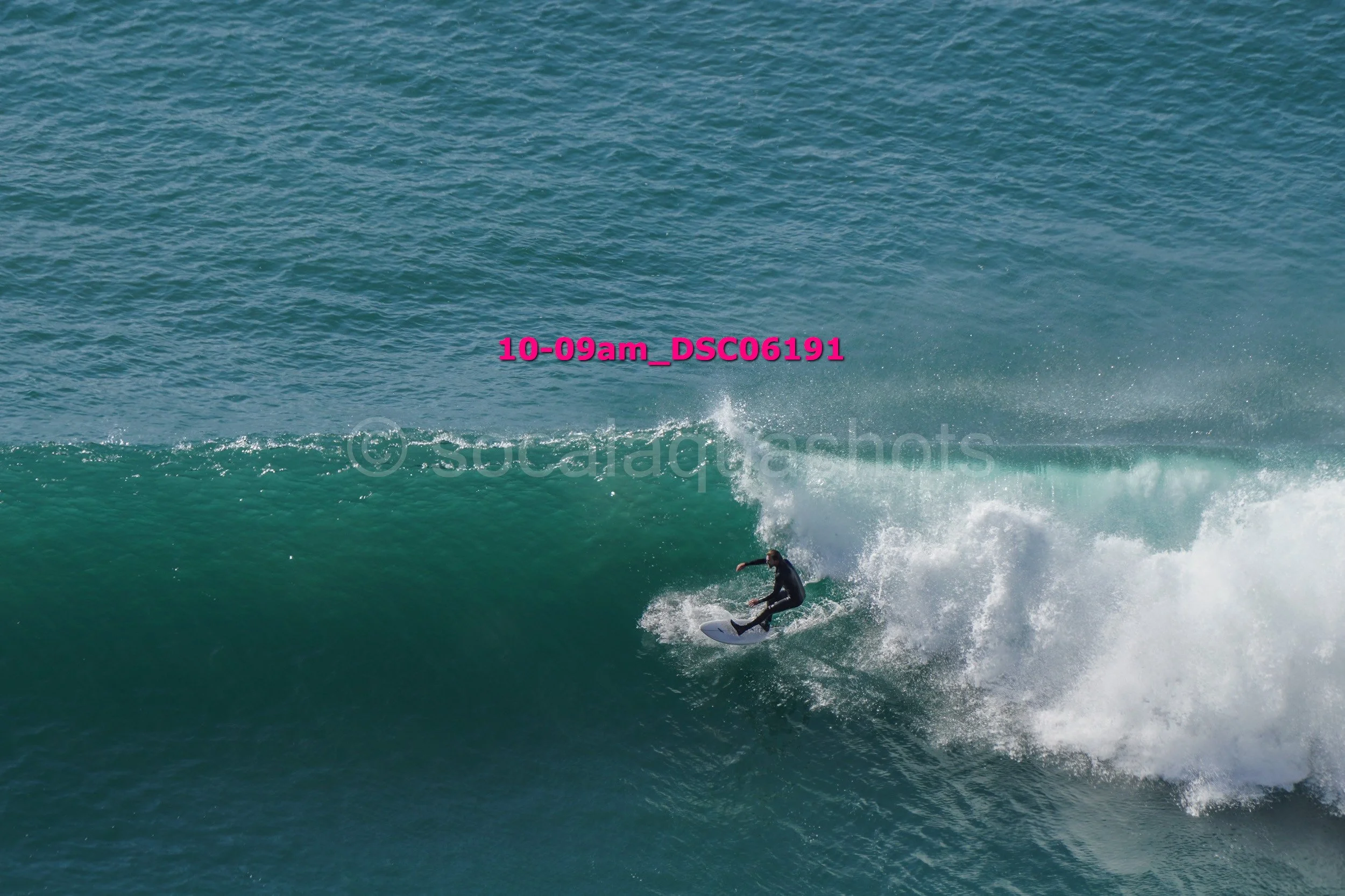 A surfer riding a wave in the ocean.