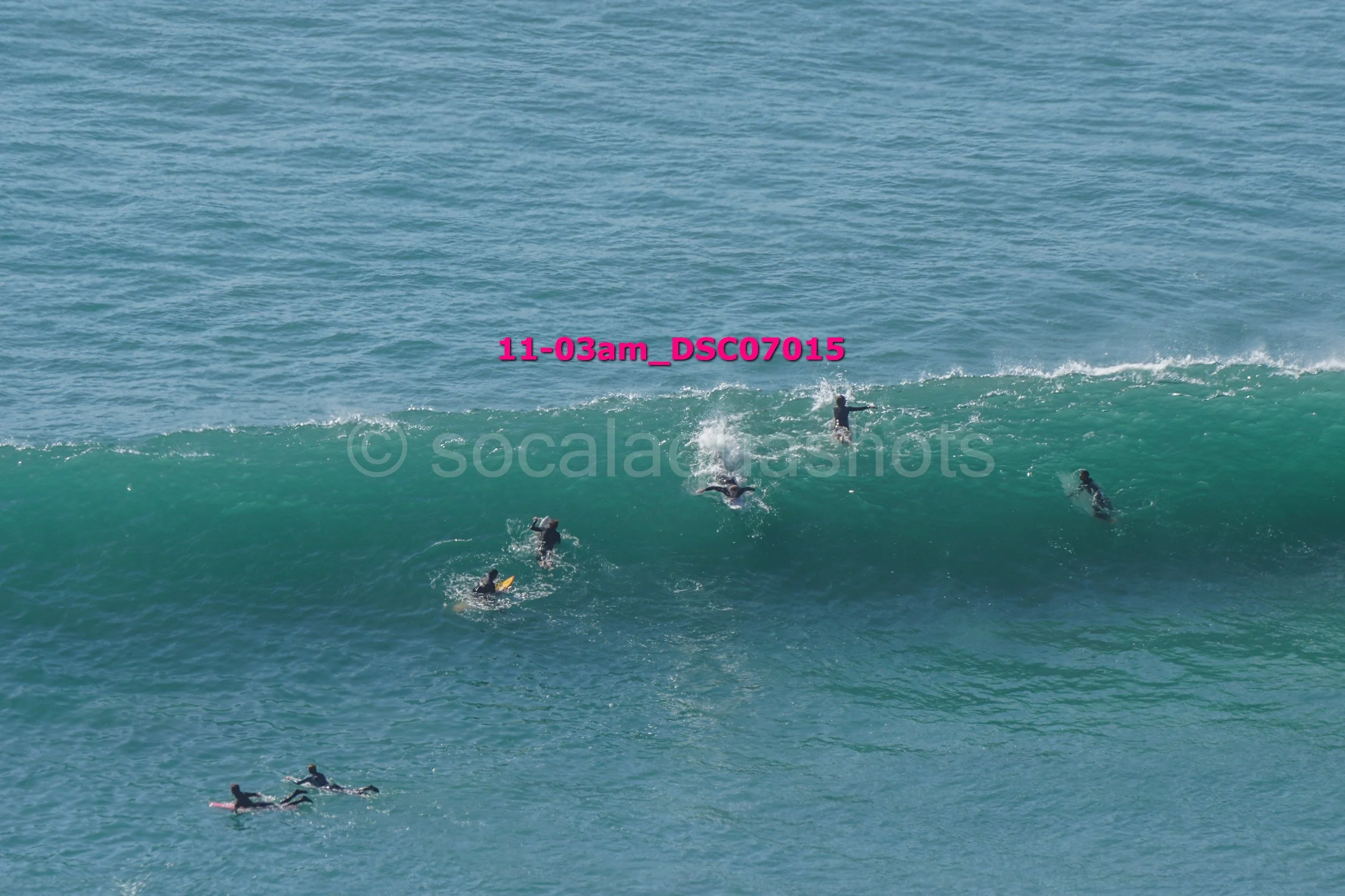 Multiple surfers riding and swimming in ocean waves
