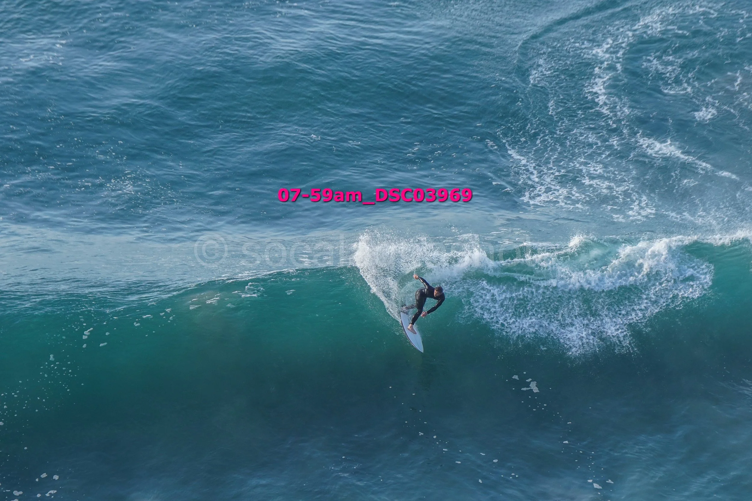A person surfing on a wave in the ocean.