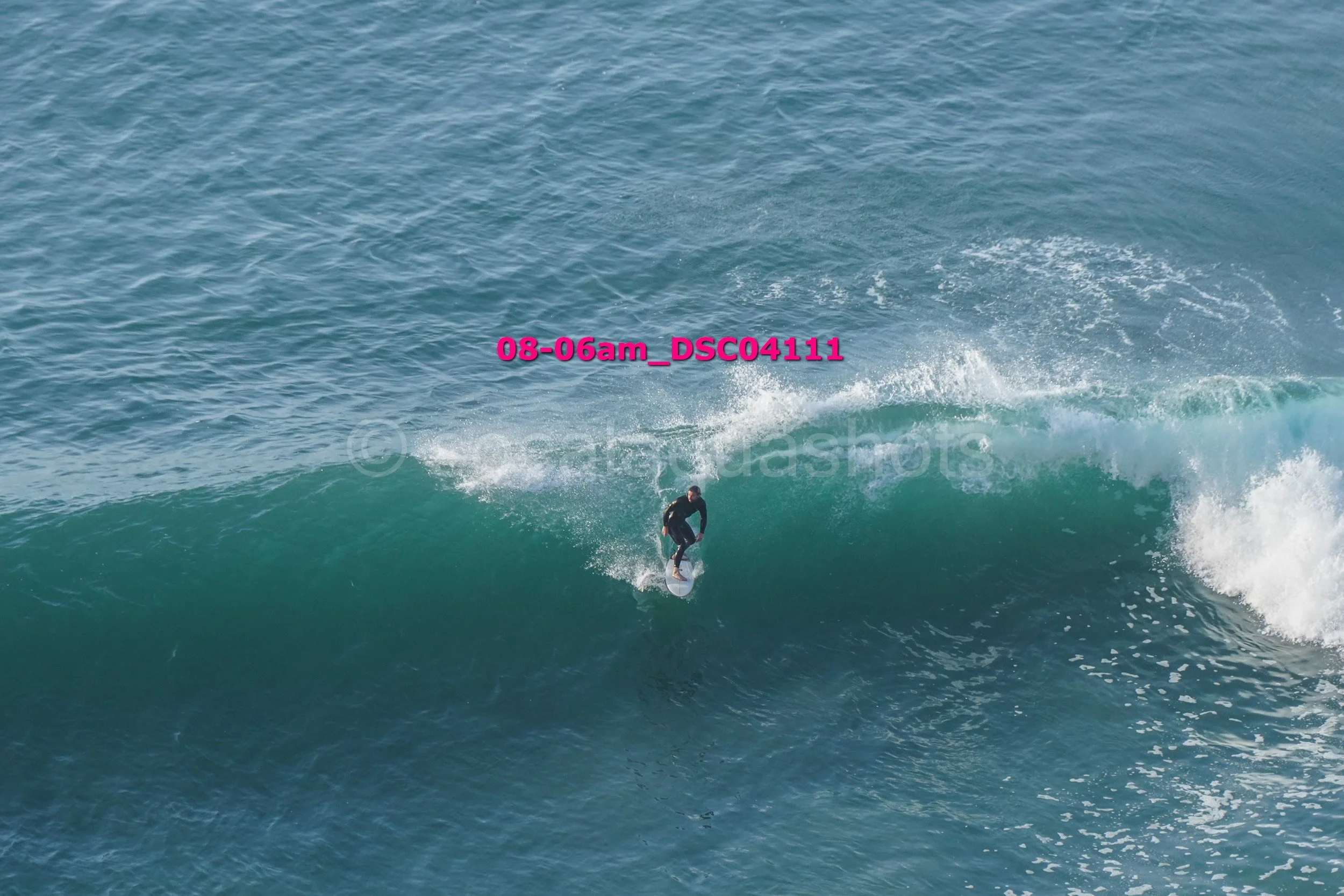 A person surfing on a wave in the ocean.