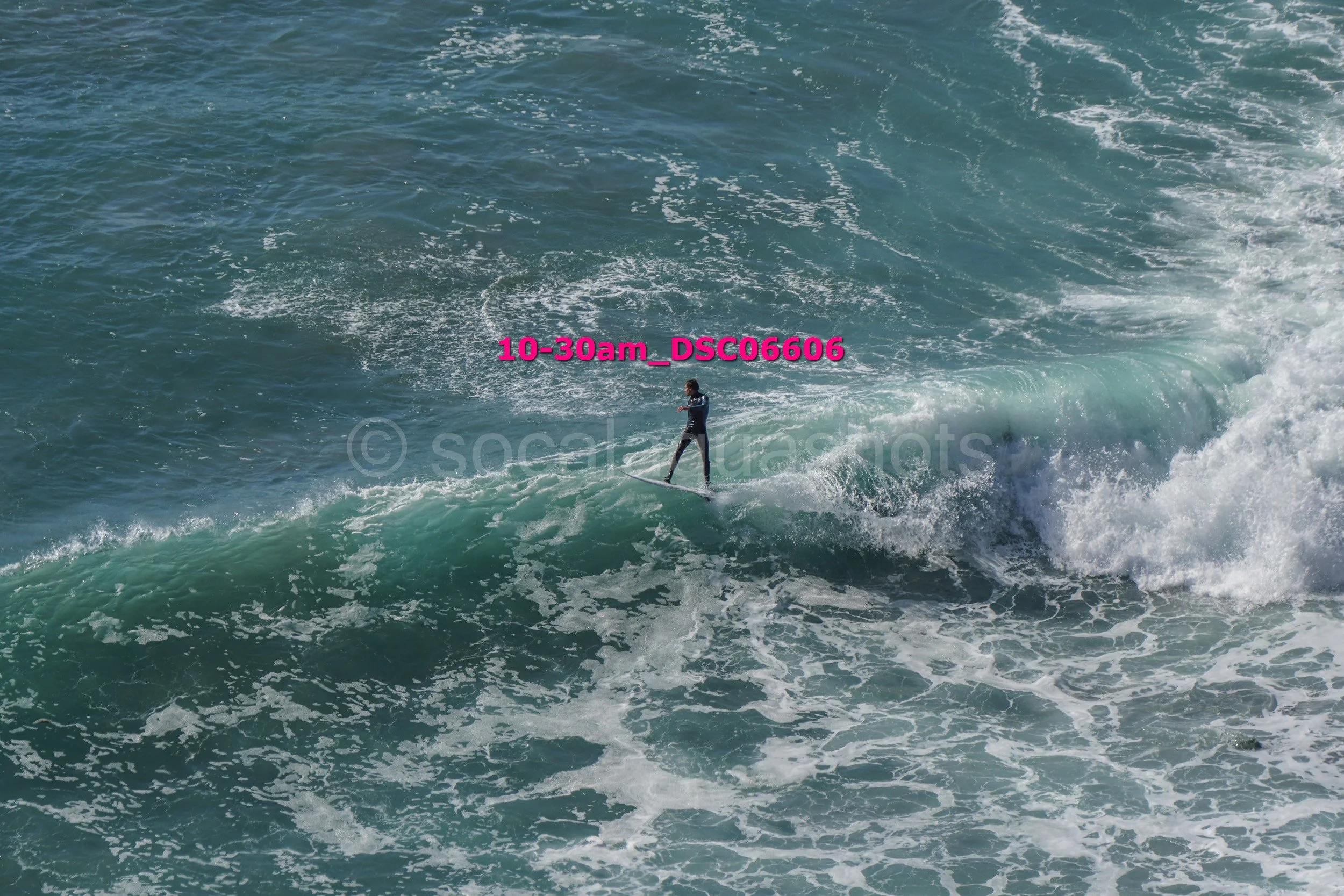 A person surfing on a wave in the ocean during daytime.