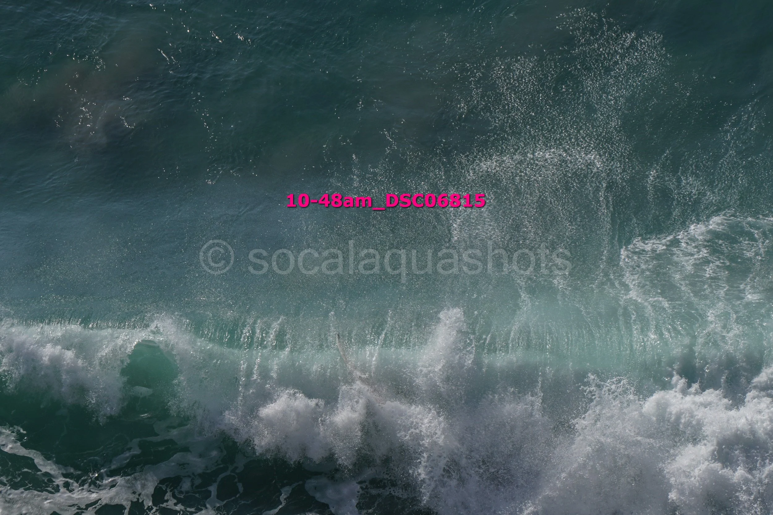 Ocean waves with white foam crashing, aerial view