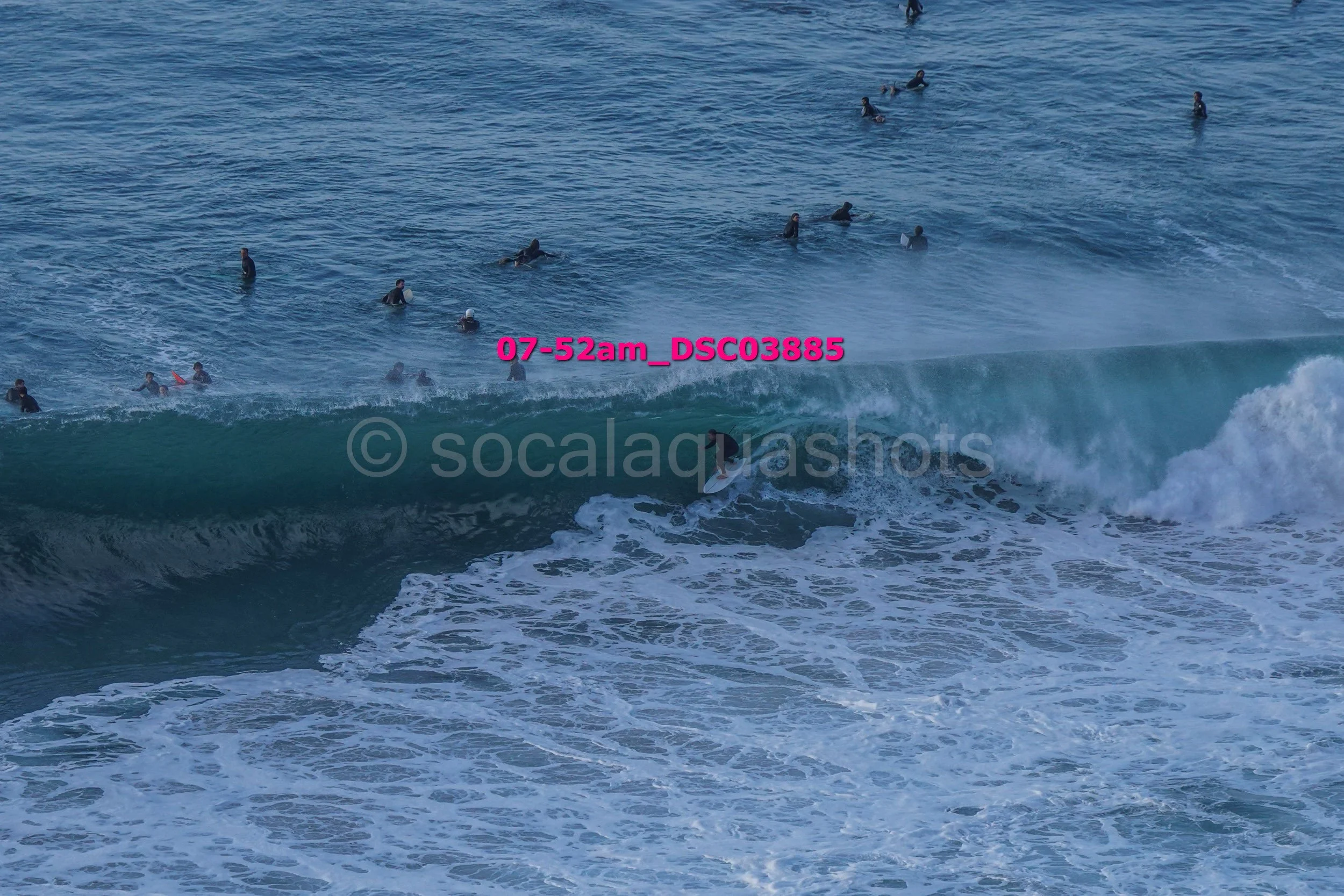 People surfing and swimming in the ocean with waves