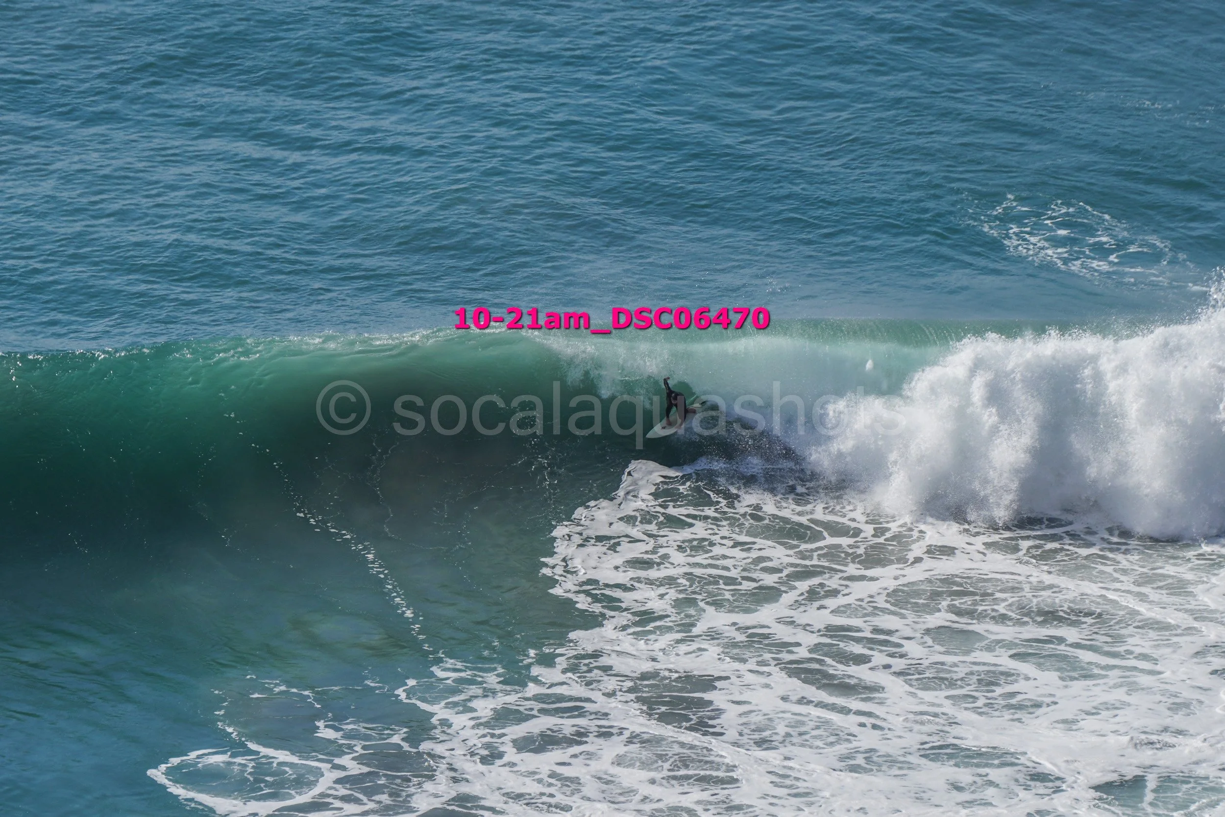 A person surfing on a wave in the ocean.