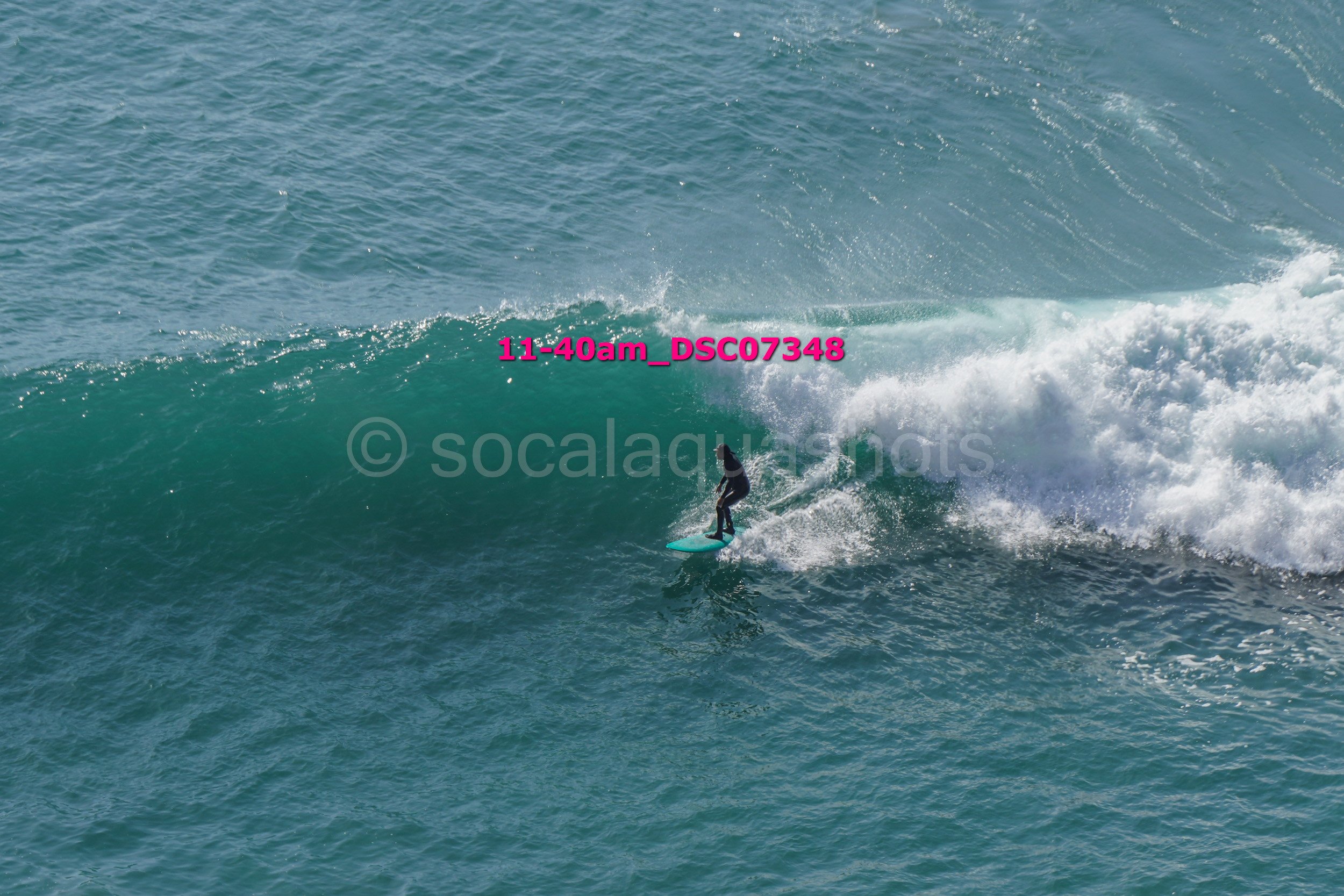 A person surfing on a large wave in the ocean