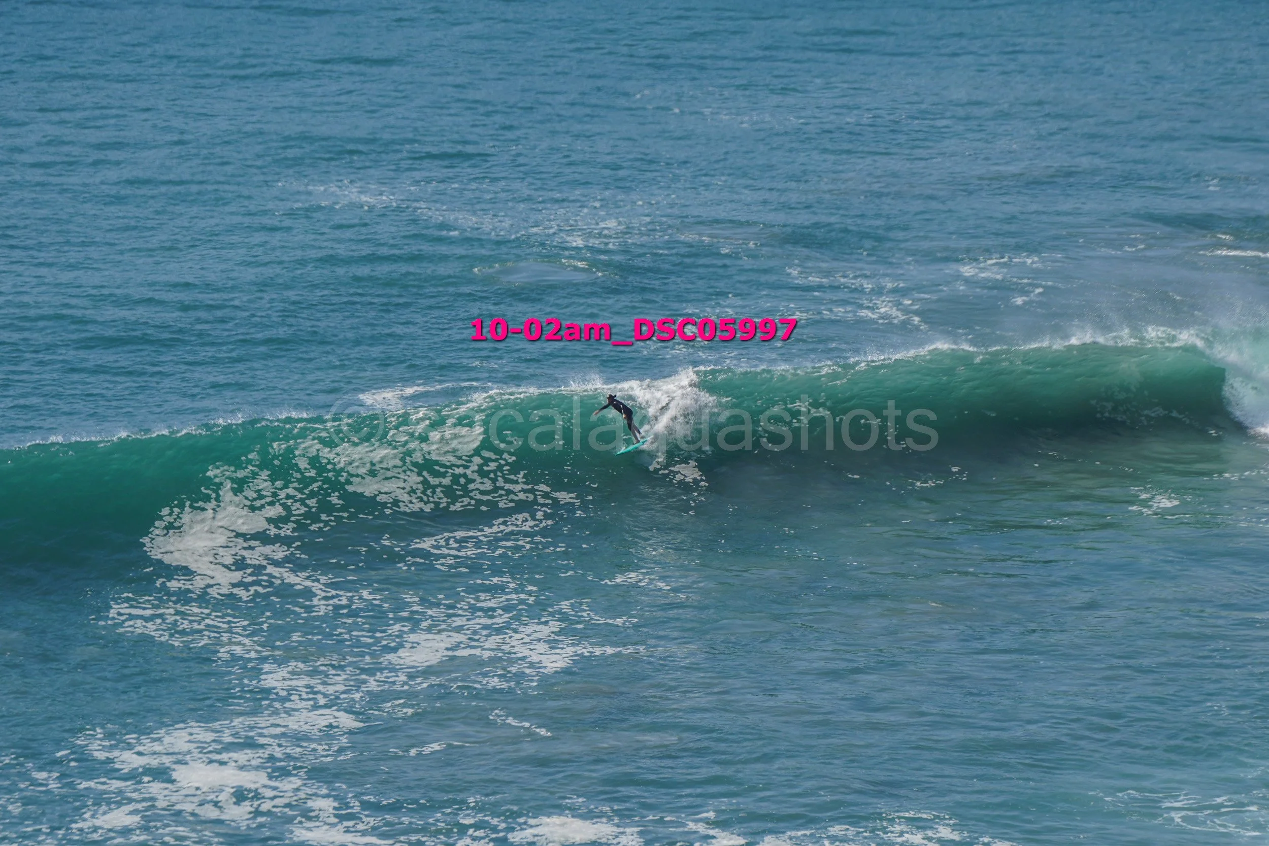 Surfer riding a wave in the ocean.
