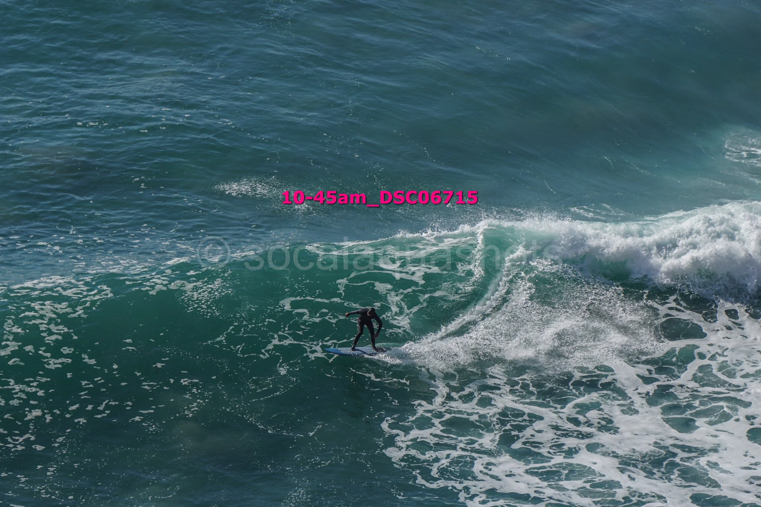 A person surfing on a wave in the ocean with the text '10-45am_DSC0715' overlaid.