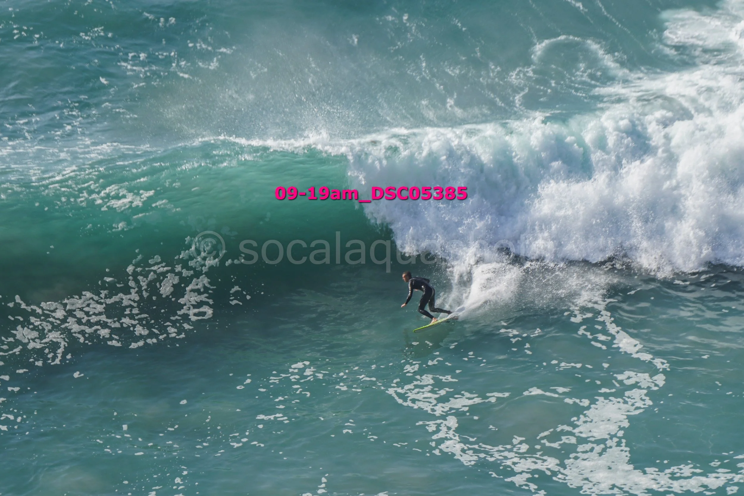 Surfer riding a large wave in the ocean.