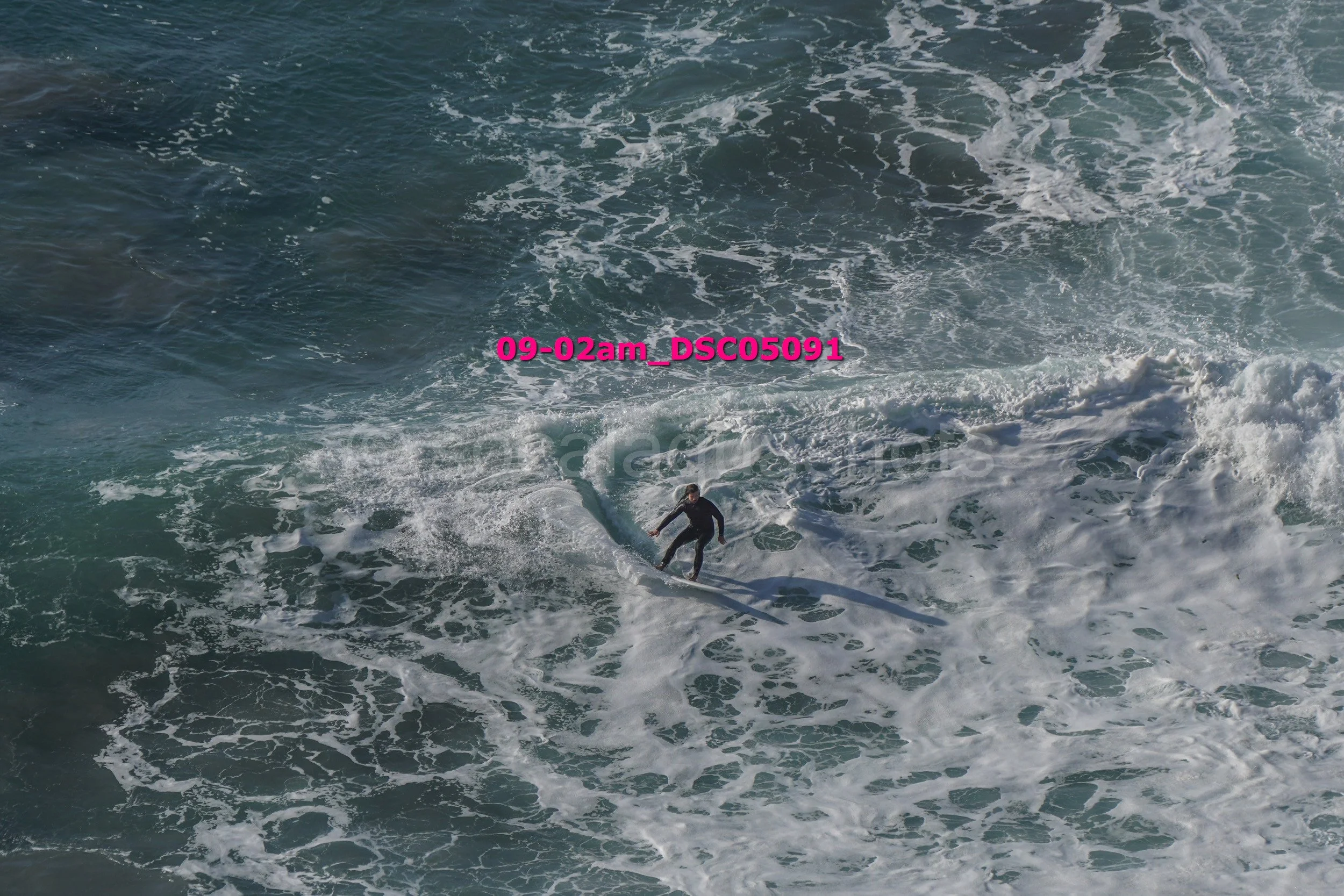 A person surfing on a wave in the ocean.