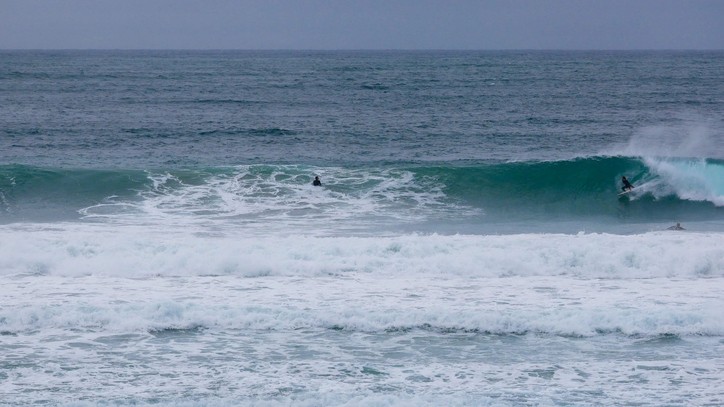 Surfers riding waves in the ocean