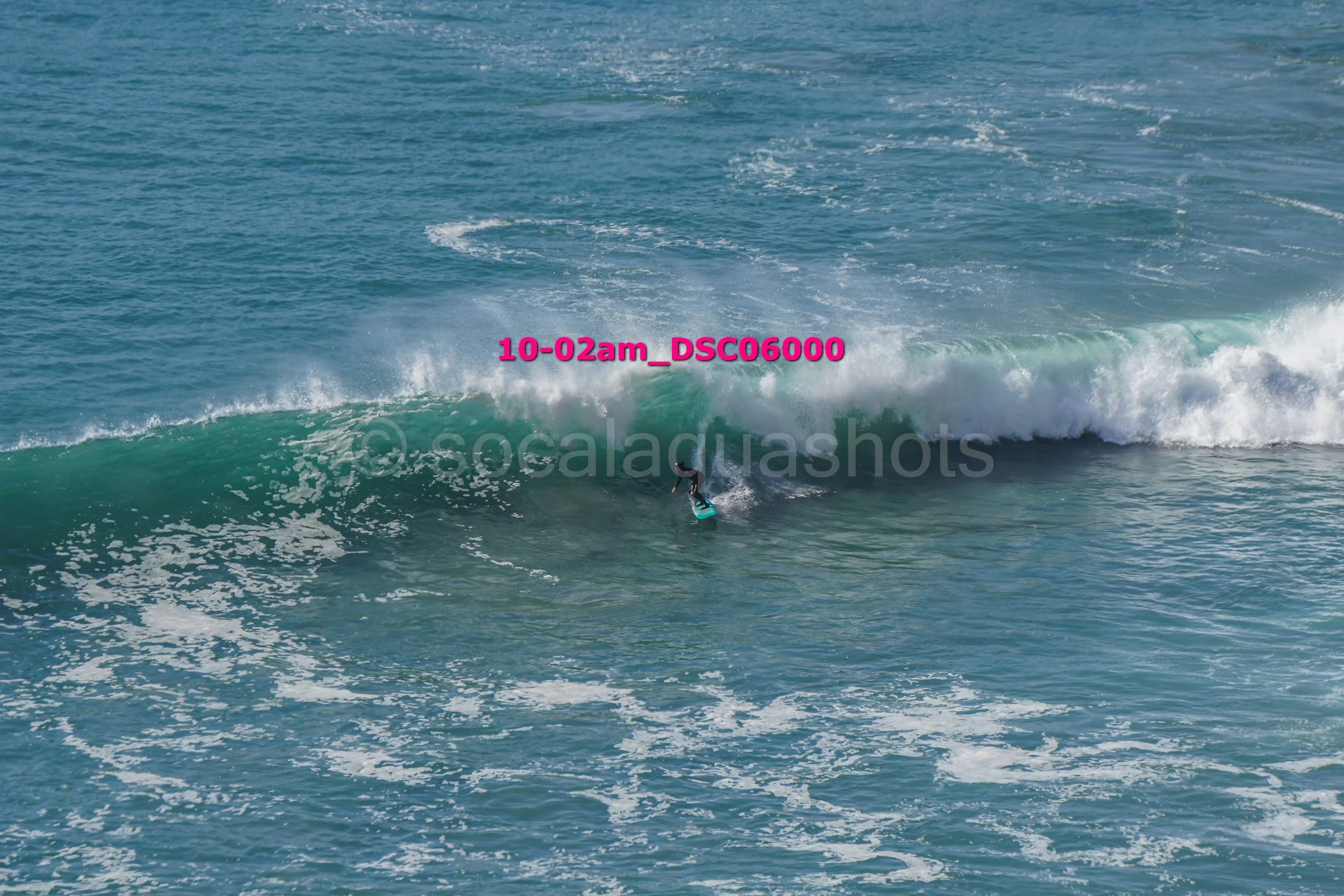 A person surfing on a wave in the ocean.