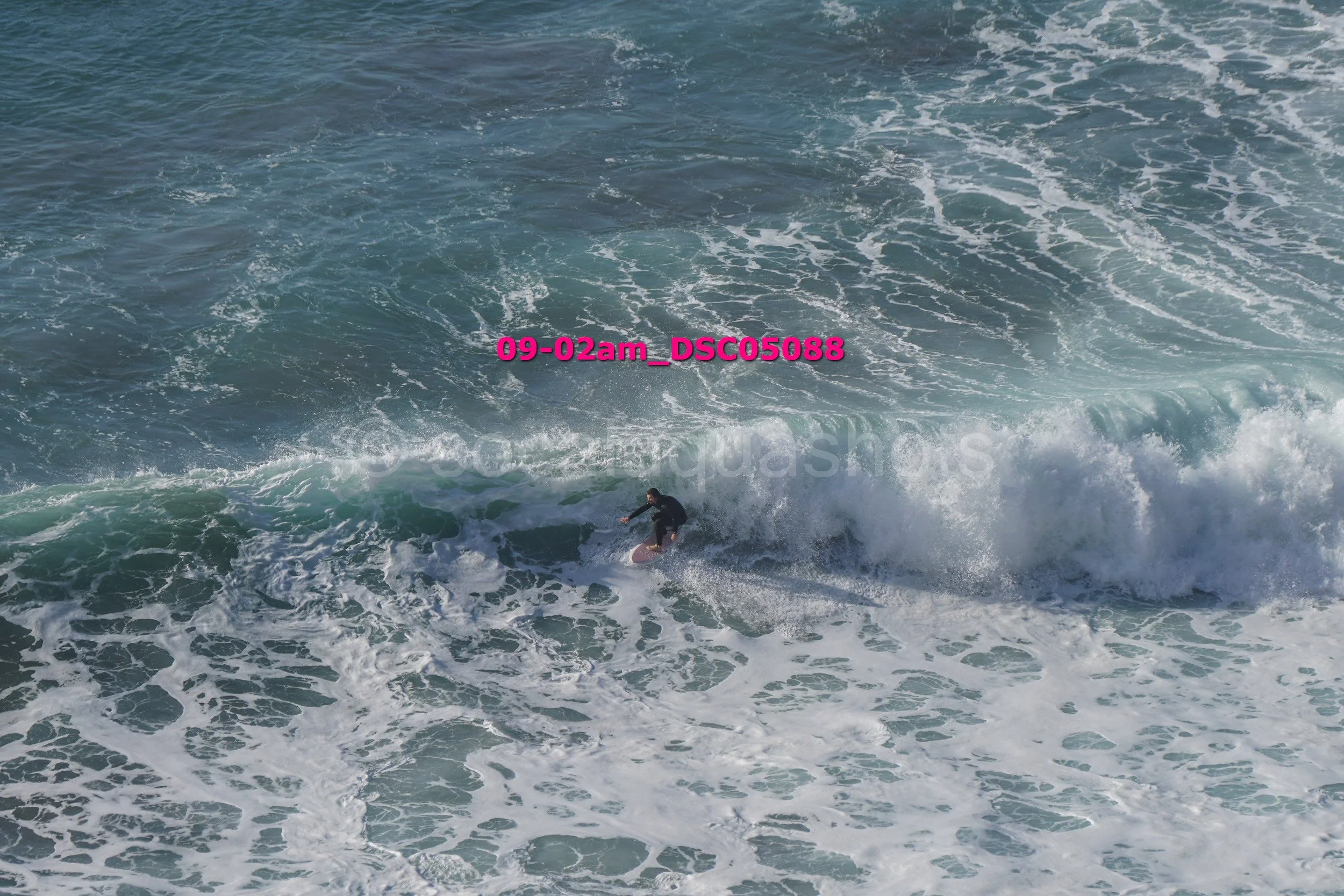 A person surfing white waves in the ocean.