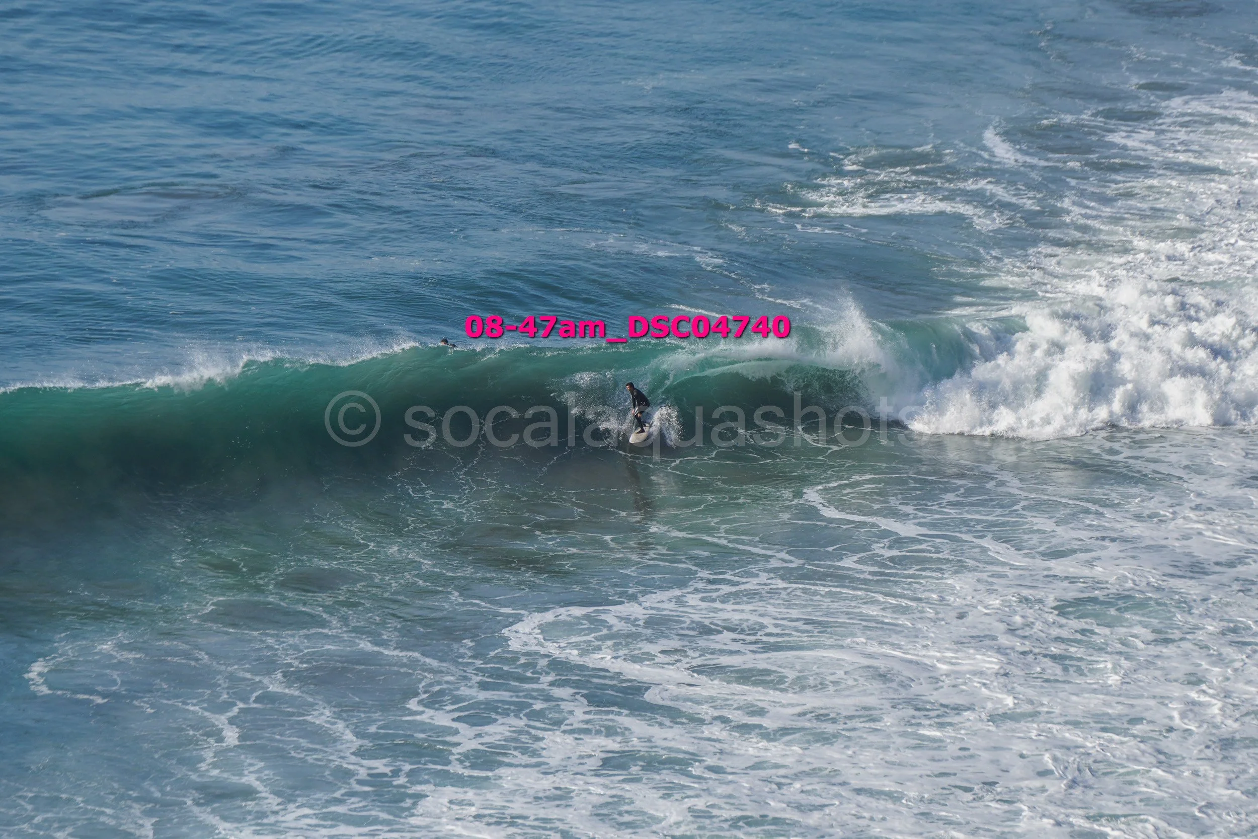 A person surfing on a wave in the ocean
