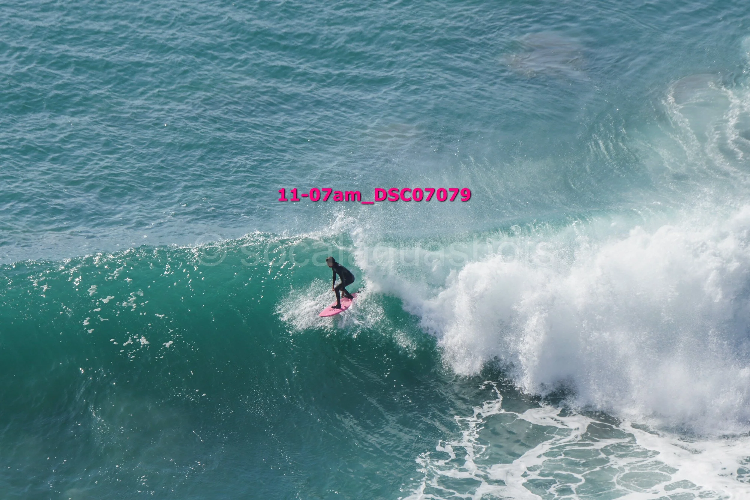 Surfer riding a large breaking wave in the ocean.