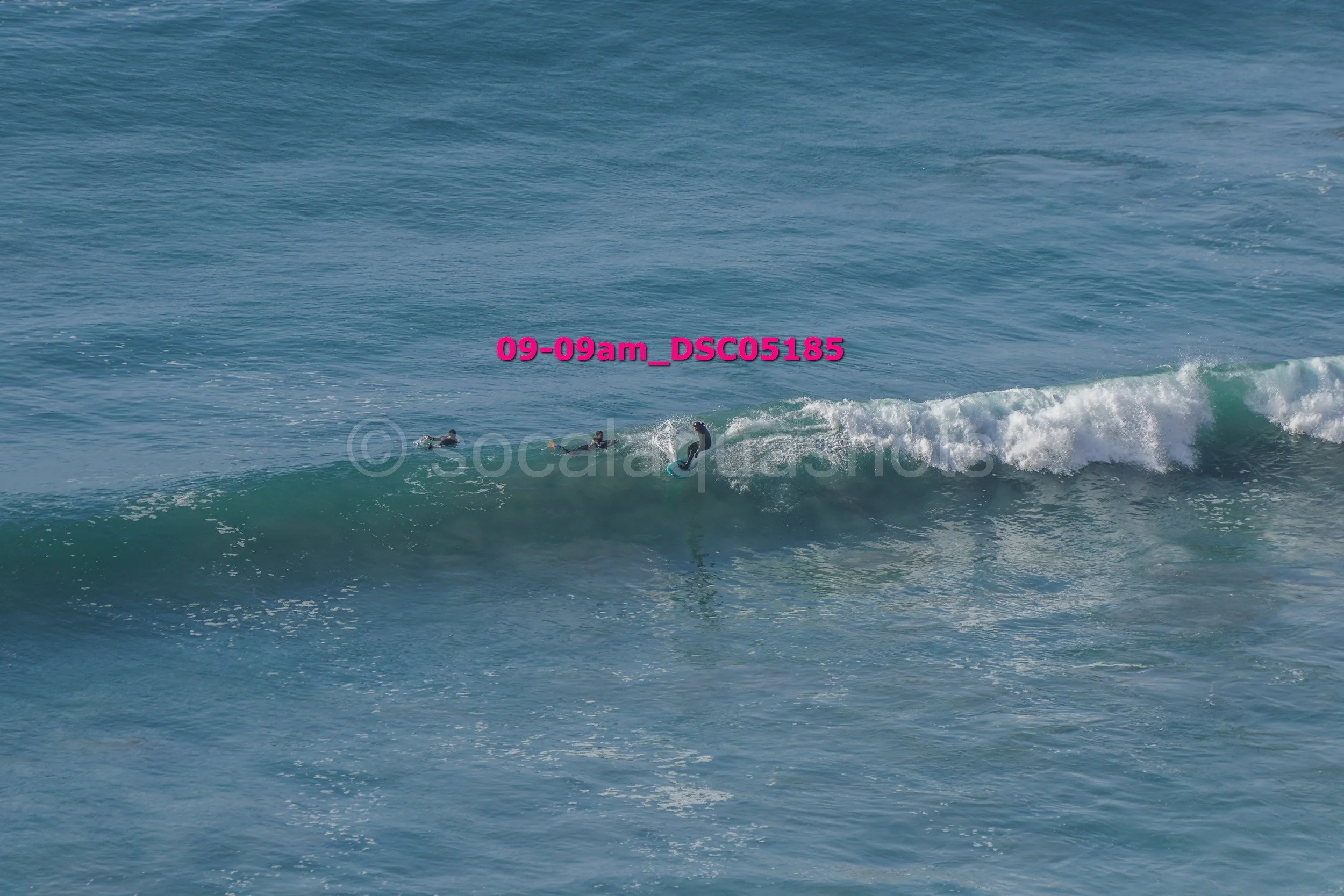 Two surfers riding a wave in the ocean.