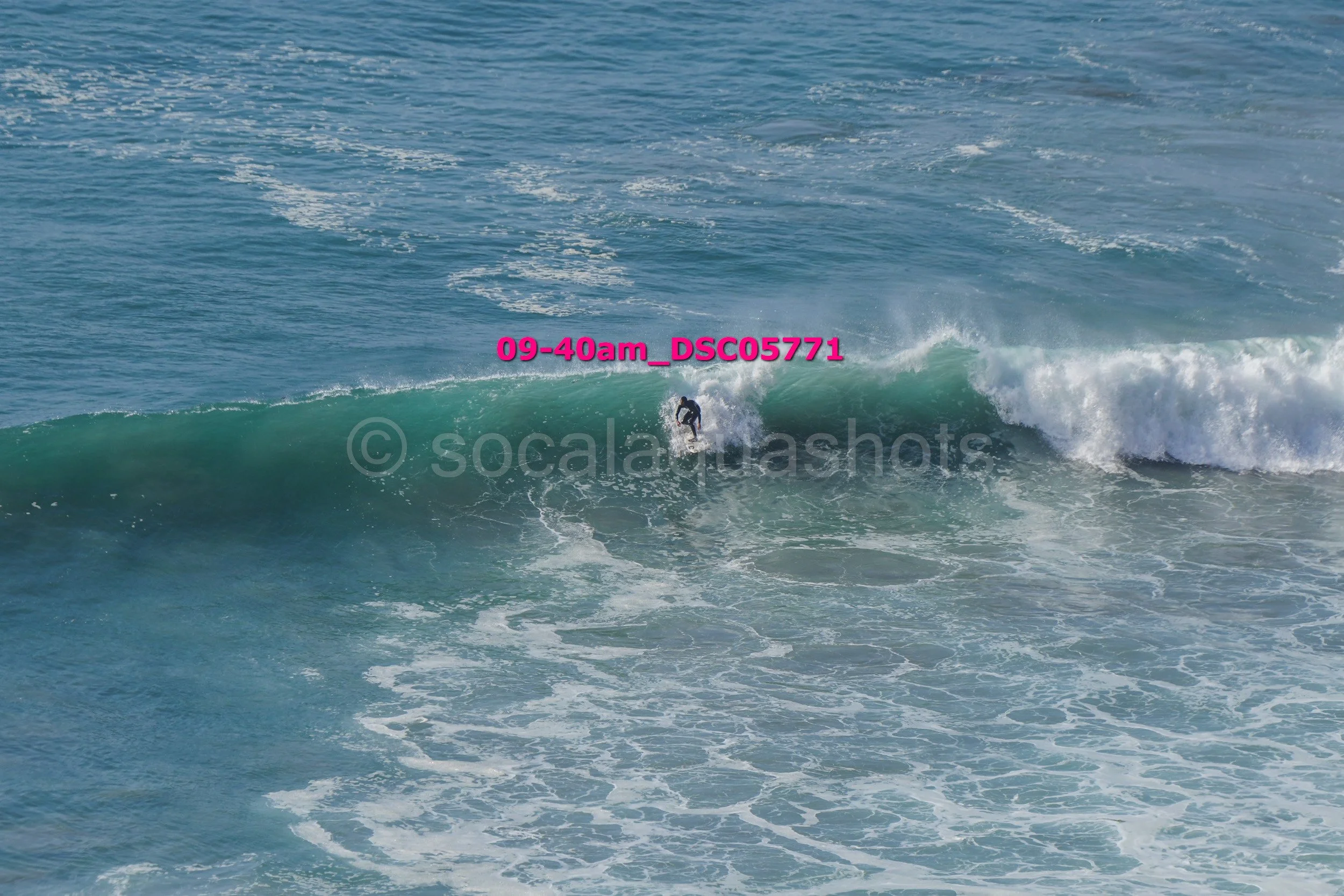 A surfer riding a wave in the ocean.