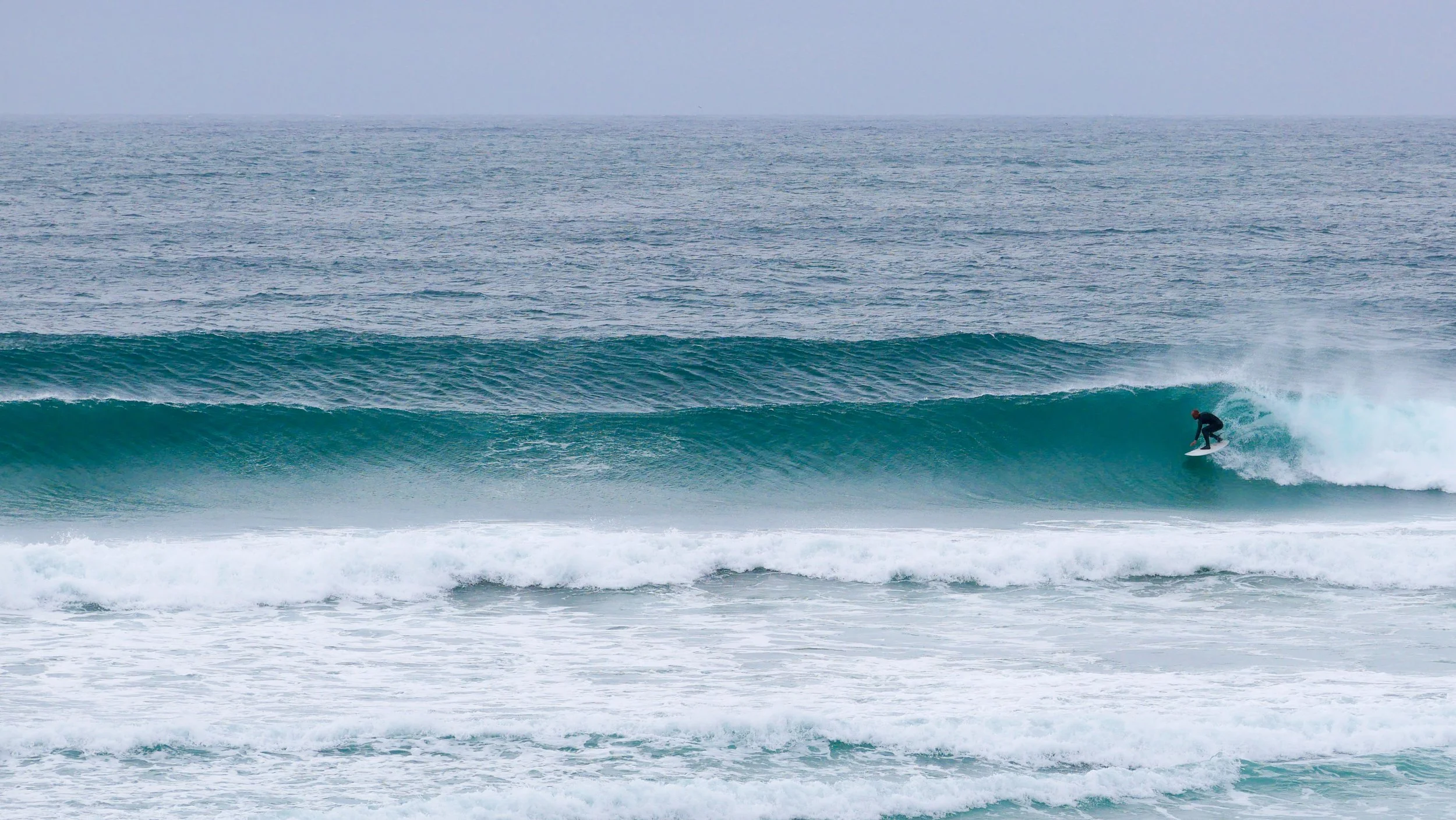 Surfer riding a wave in the ocean