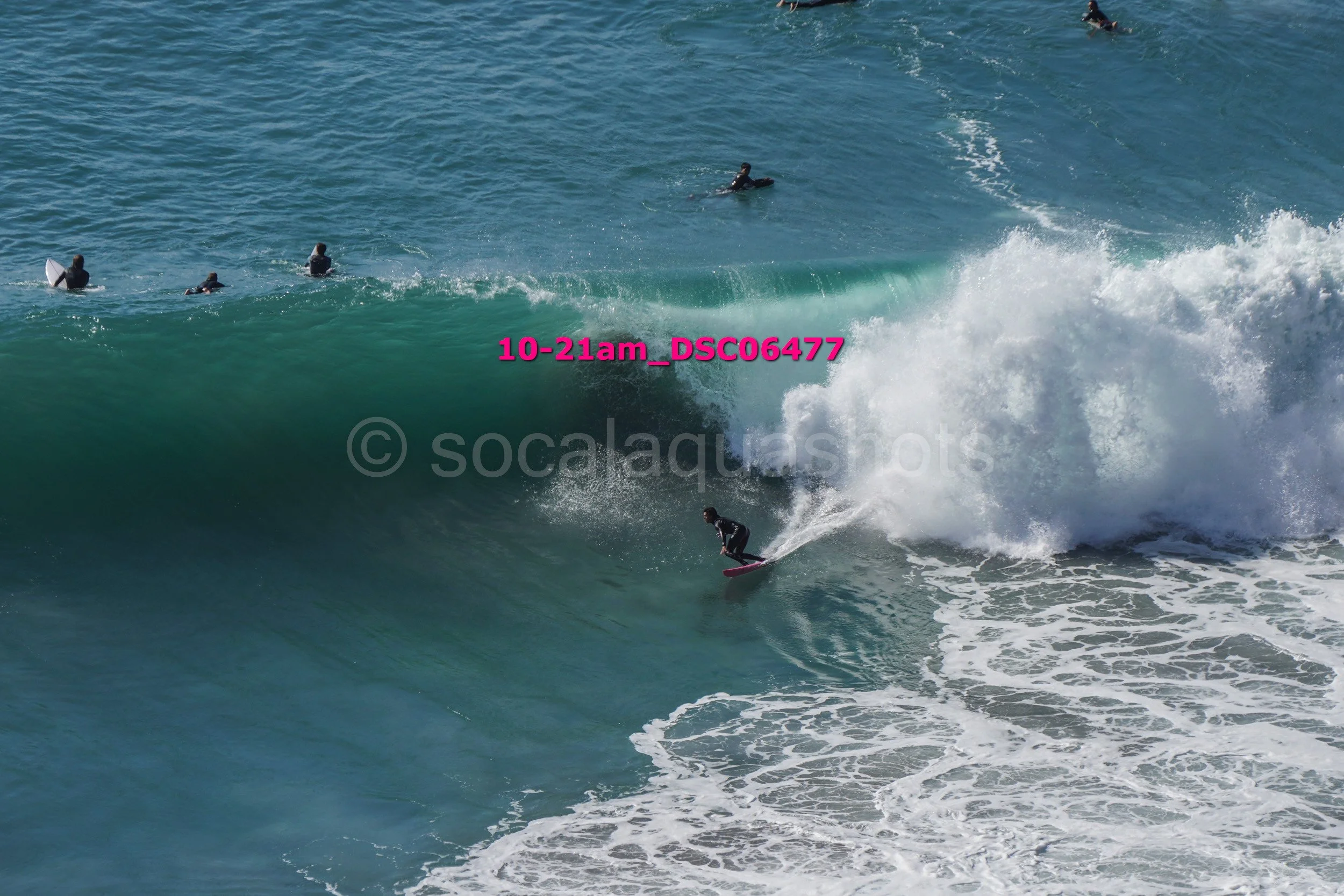 Surfer riding a wave with surfers in the background