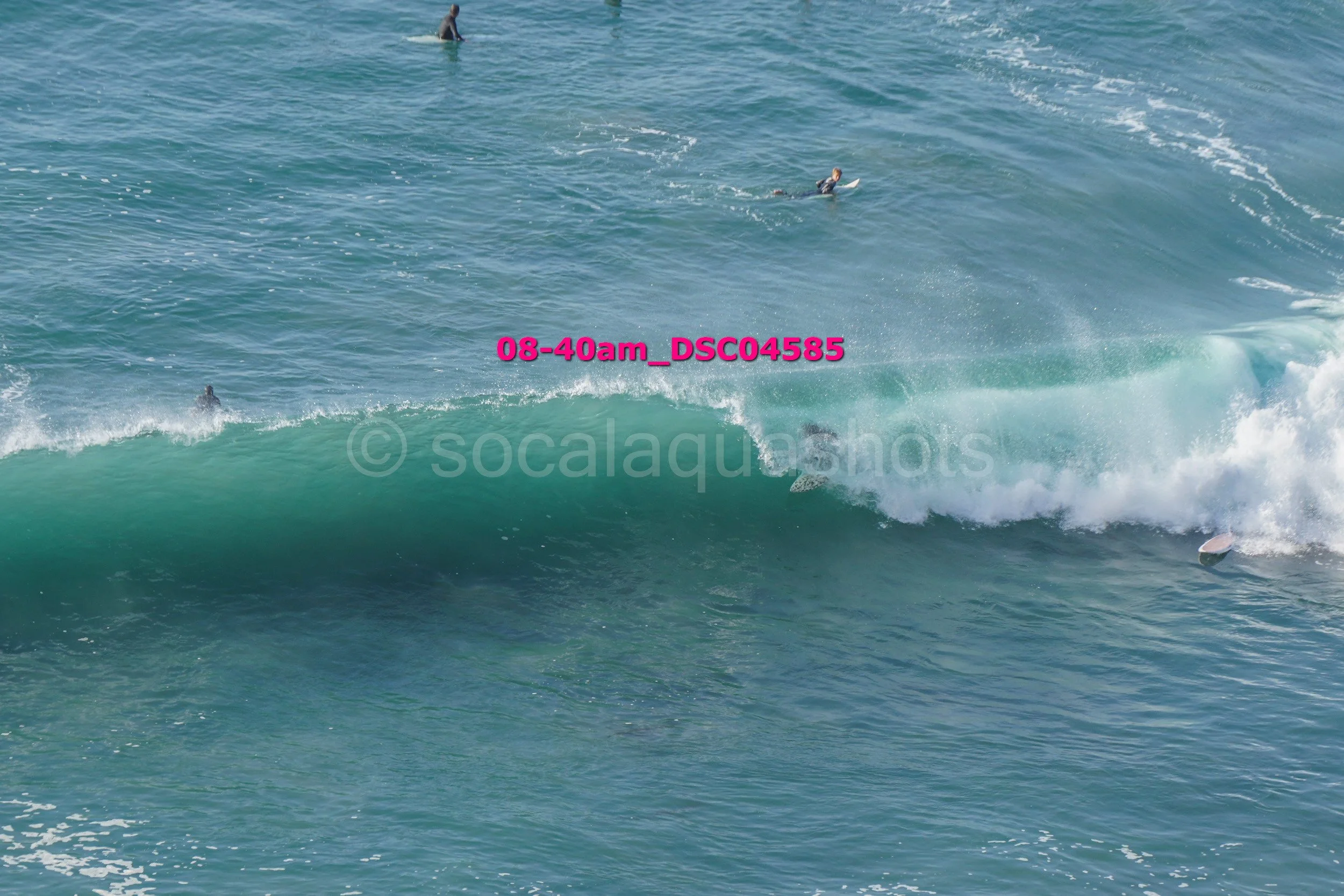 People surfing in the ocean with waves and surfboards