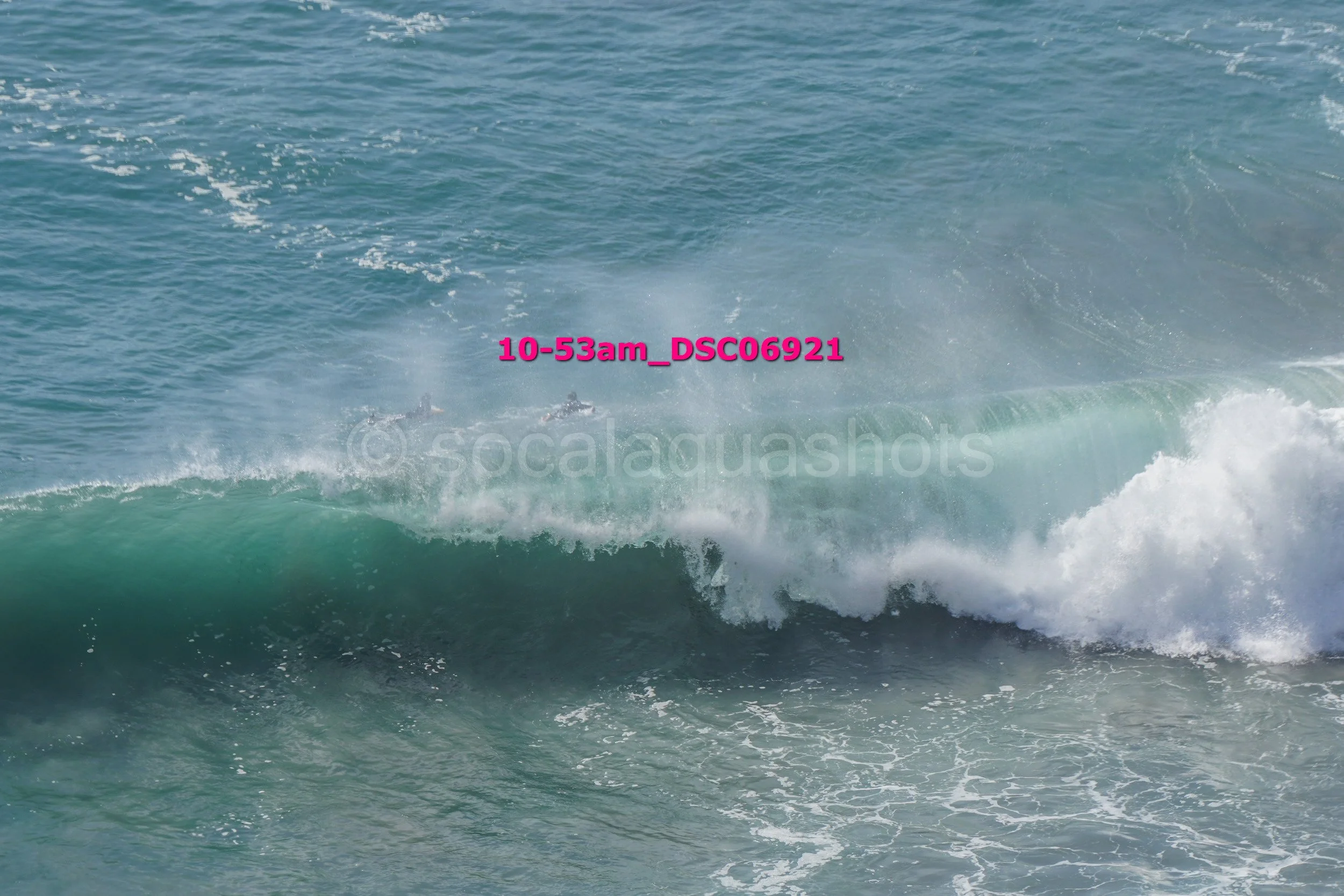 Oceans waves with visible spray and foam.