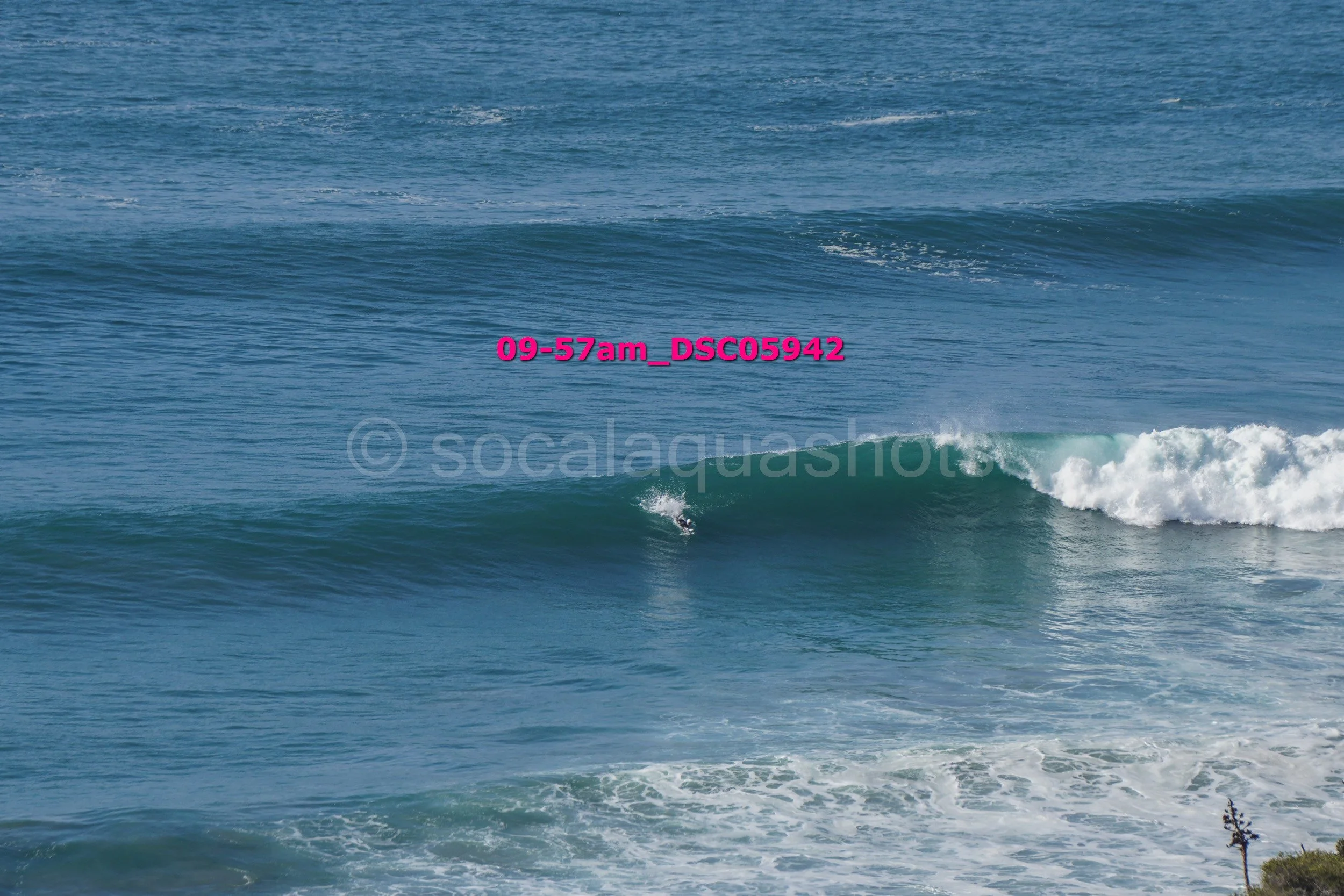 Ocean waves with a surfer in the water