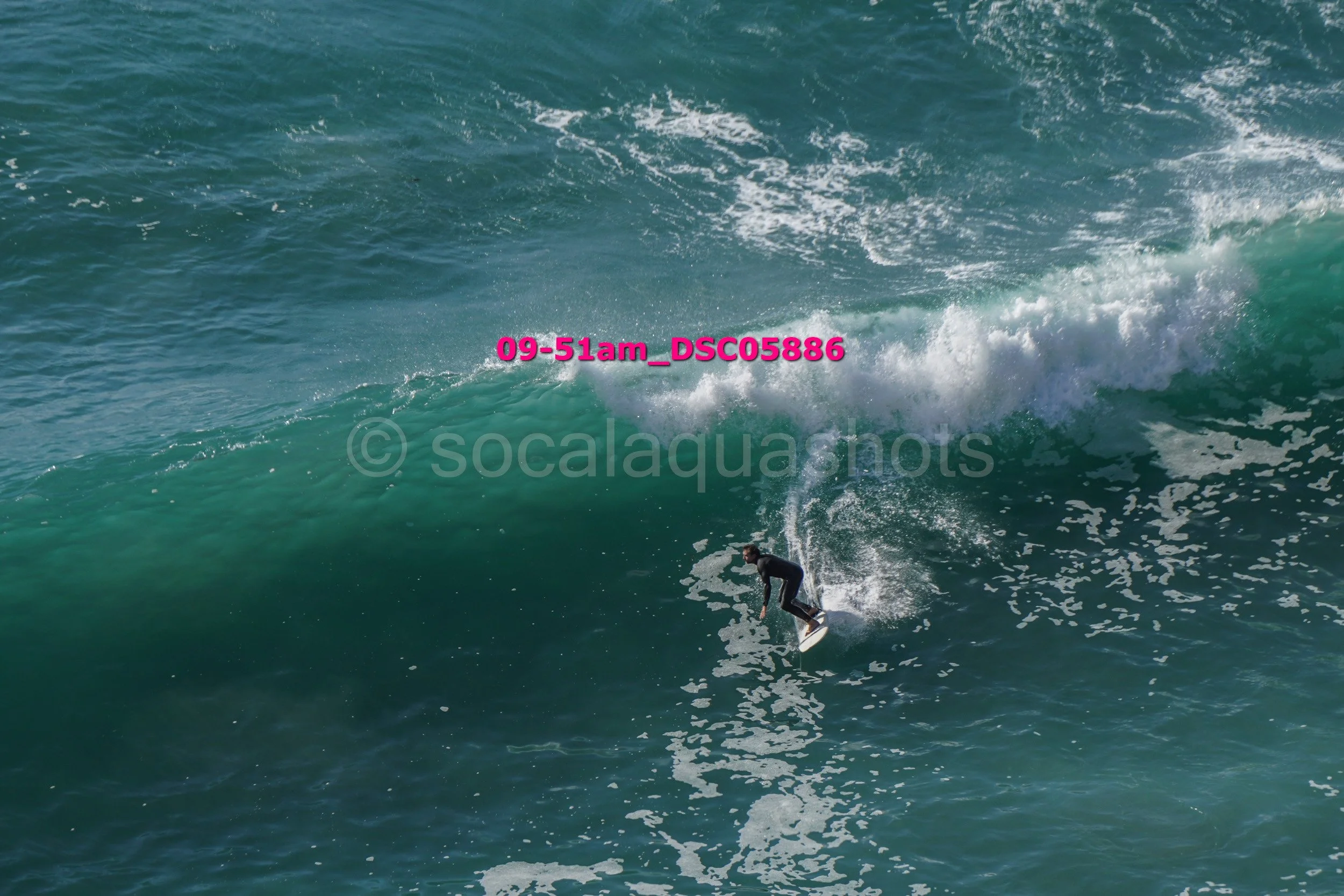 A person surfing on a large ocean wave.